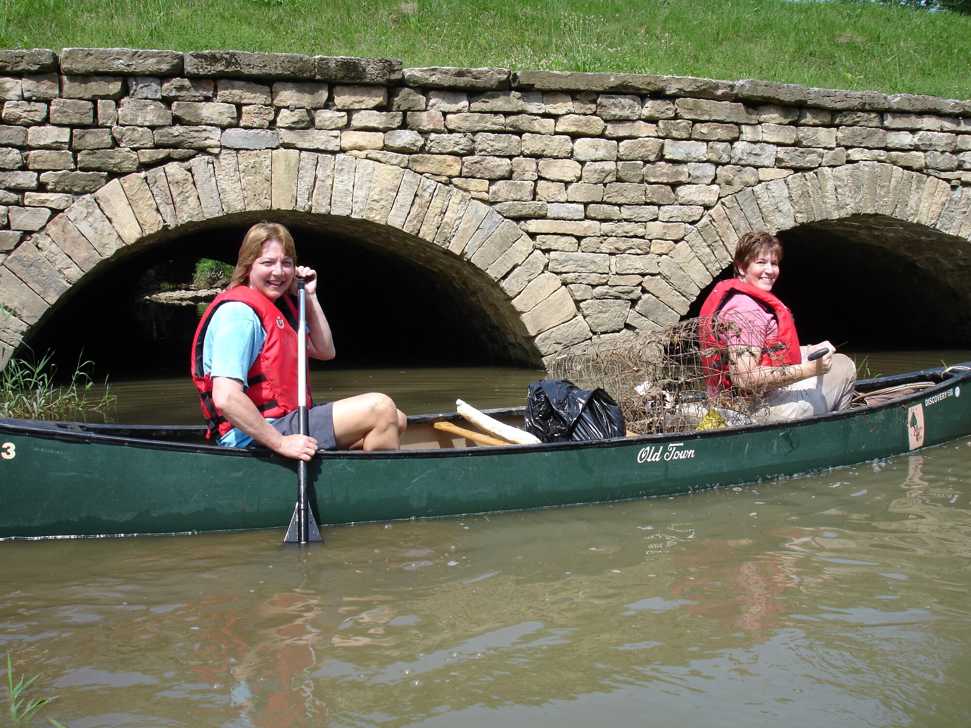 WRIGHT-PATTERSON AFB, Ohio - Master Sgt. Karen Miller, 445th Airlift Wing, and Senior Master Sgt. Alice Collingwood, 445th Logistics Readiness Squadron, canoe along the Great Miami River picking up debris along the way.  The two reservists participated in the annual Clean Sweep , a campaign to beautify the area from Indian Lake to Franklin, Ohio. (Courtesy photo)
