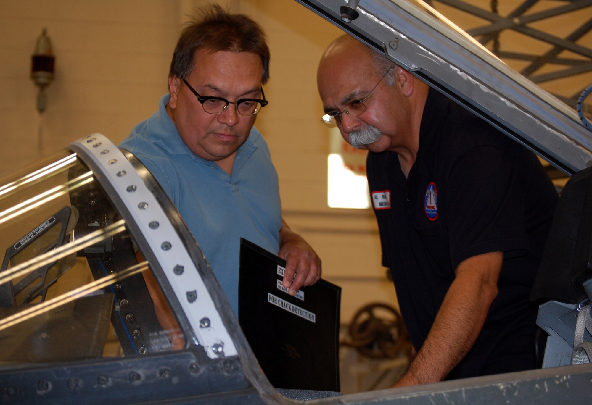 LAUGHLIN AIR FORCE BASE, Texas-- Ruben Medellin and John Sanchez check the cockpit of a T-38 before performing X-ray method of inspection here July 25. Medellin and Sanchez are both members of the Non-Destructive Inspection unit with the 47th Maintenance Directorate. Members of the NDI are responsible for performing inspections on the T-1, T-6, and T-38 aircraft looking primarily for cracks and other degradation factors such as water in the honeycomb, corrosion, or disbonding of the flight control surfaces. (U.S. Air Force photo/Staff Sgt. Olufemi A. Owolabi)