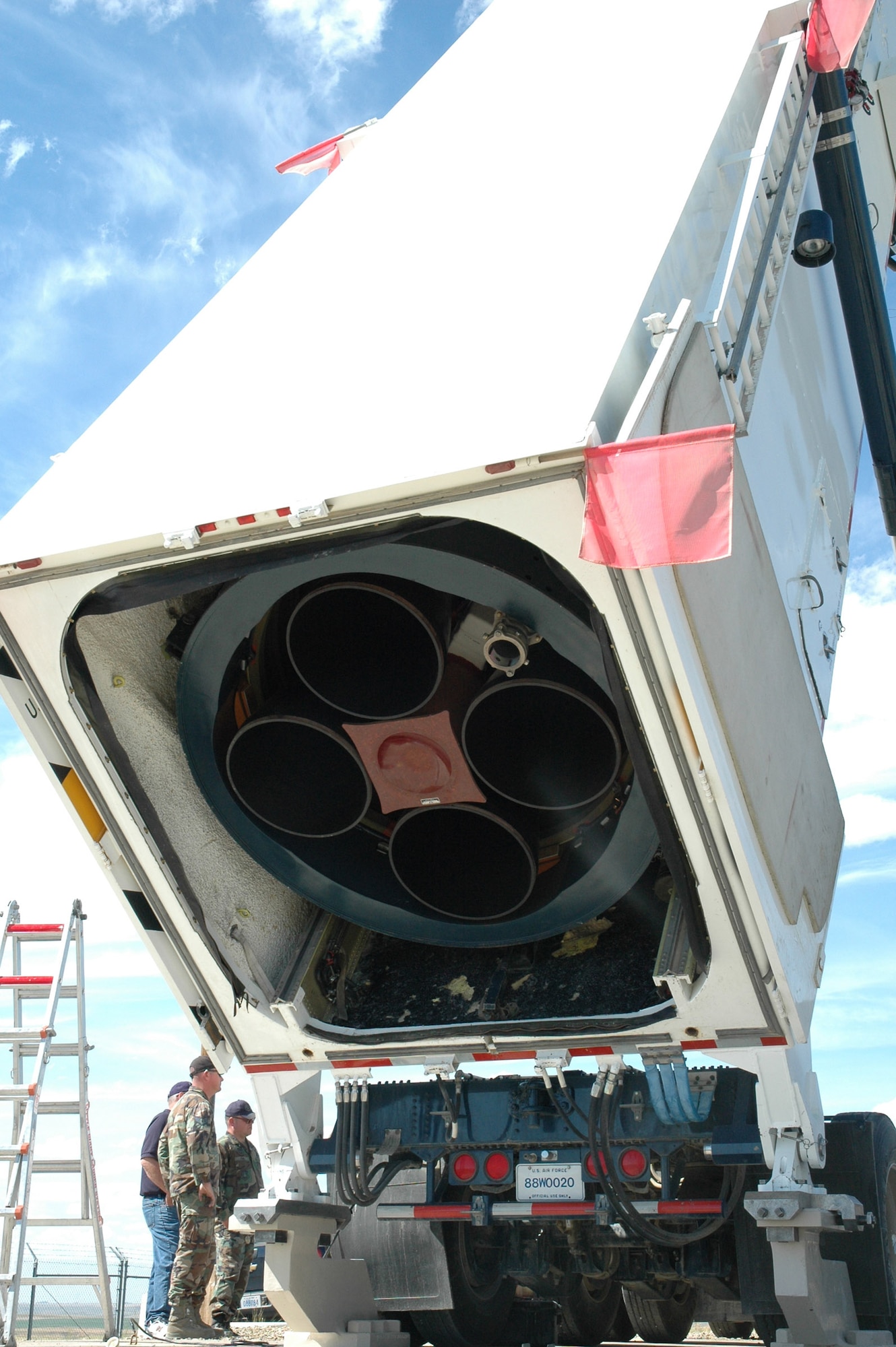 Maintainers look on as the payload transporter extracts the final weapon system component from the 564th. The pull was conducted July 28 and marked the completion of the decomissioning of the 564th Missile Squadron. (U.S. Air Force photo/Airman 1st Class Emerald Ralston)