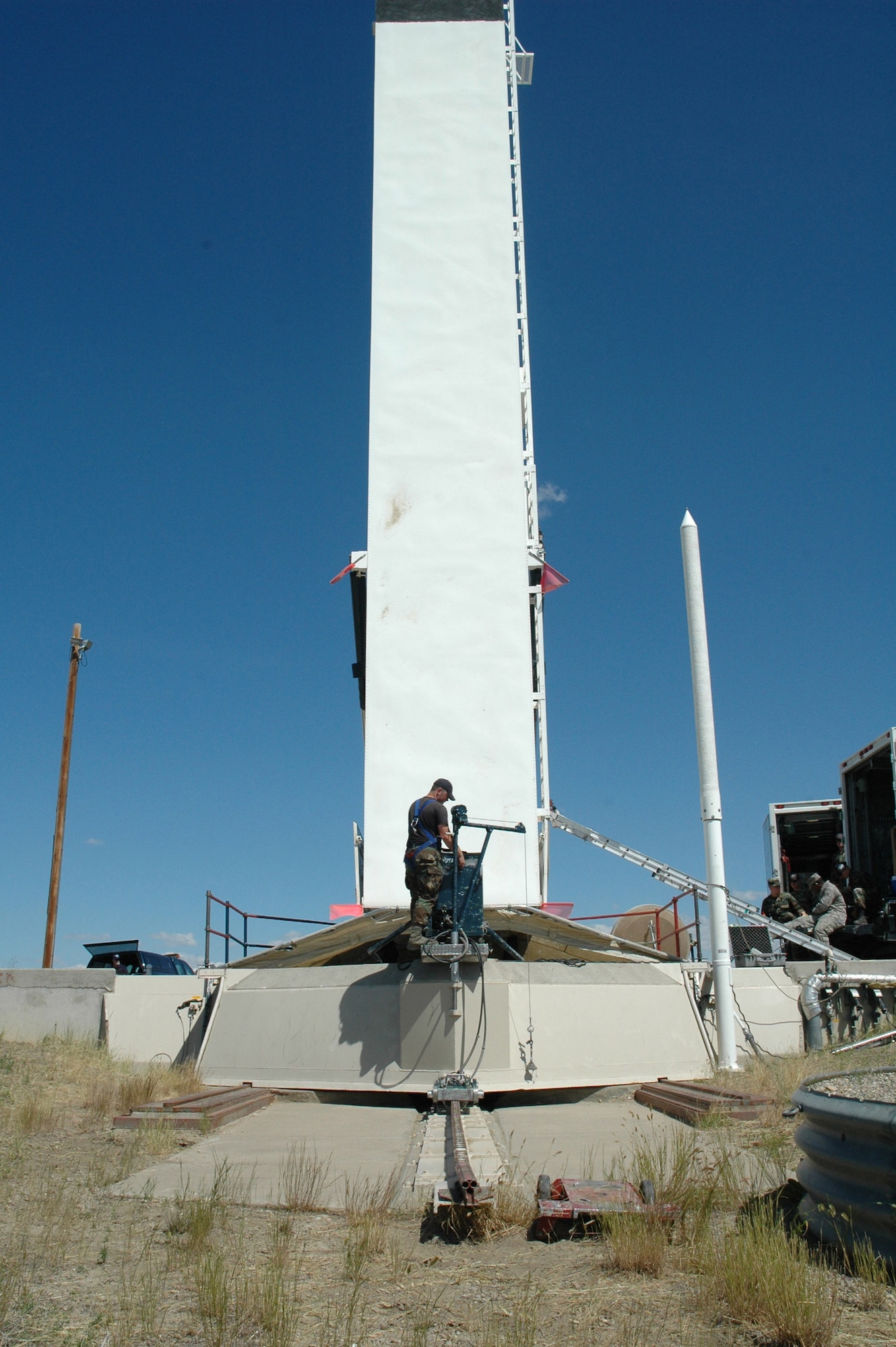 AIrman 1st Class Brant Hoover, 341st Missile Maintenance Squadron, opens the launcher closure door with a hydraulic pipe-pusher prior to extracting the final weapon component from the 564th Missile Squadron at Tango 41 July 28. (U.S. Air Force photo/Airman 1st Class Emerald Ralston)
