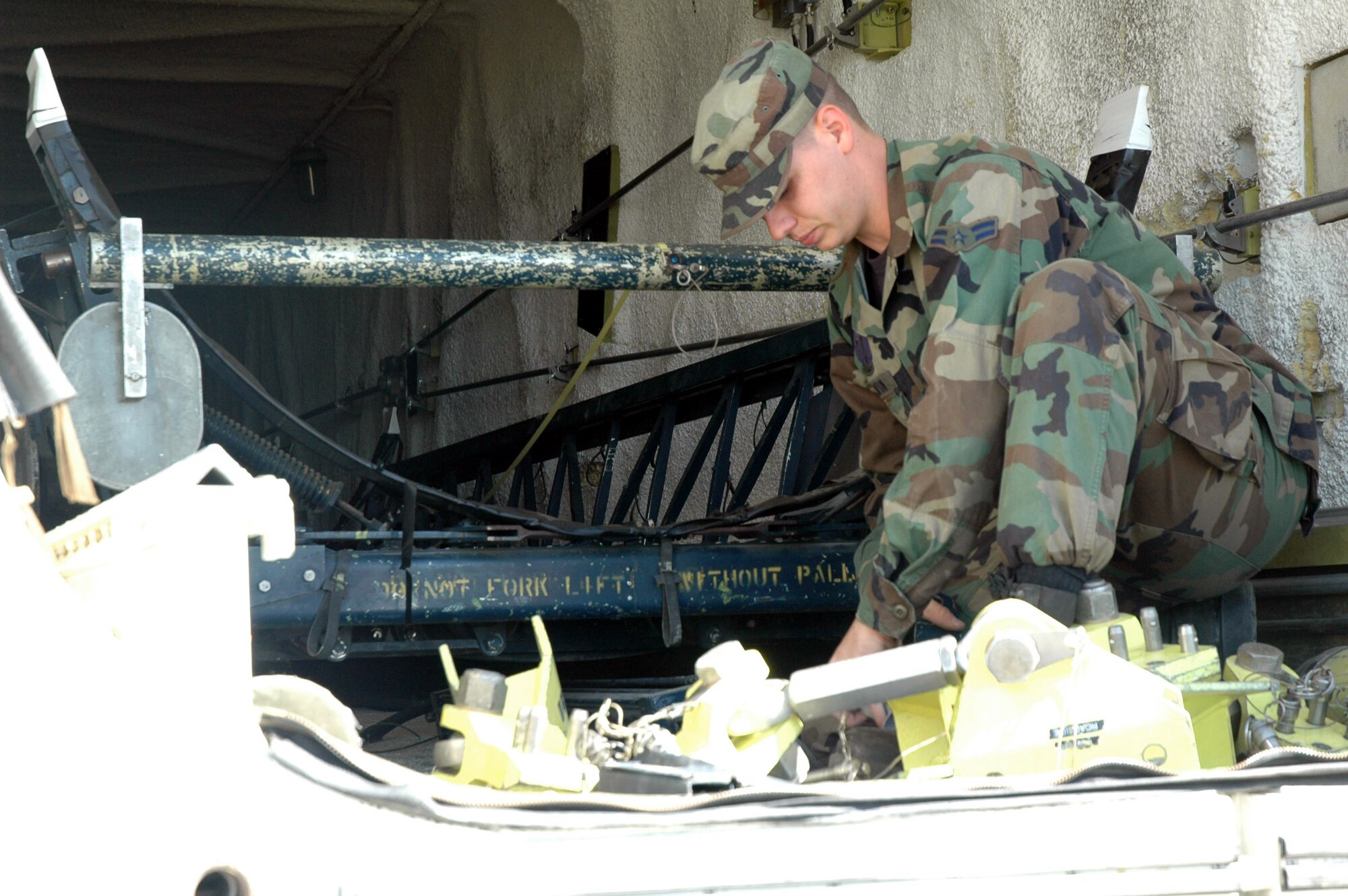 Airman 1st Class James Thompson, 341st Missile Maintenance Squadron, prepares equipment prior to erecting the payload transporter.  Maintenance presonnel extracted the final component of the 564th Missile Squadron's weapon system July 28. (U.S. Air Force photo/Airman 1st Class Emerald Ralston)