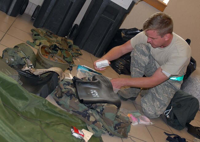 Master Sgt. Earl Wellman inspects the contents of his mobility bag one last time on base July 30 before the operational readiness inspection. Airmen across the base have been participating in weekly exercises to prepare for the ORI which begins Aug. 3. Sergeant Wellman is a production superintendent for the 437th Aircraft Maintenance Squadron. (U.S. Air Force photo/Airman 1st Class Melissa White)
