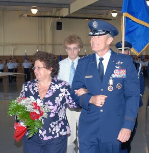 Maj. Gen. Irving Halter, outgoing 19th Air Force commander, his wife, Judy, and son, David, say goodbye to the crowd after Brig. Gen. Gregory Feest took command during a change of command ceremony July 30 in Hangar 4 at Randolph Air Force Base, Texas. (U.S. Air Force photo by Rich McFadden)