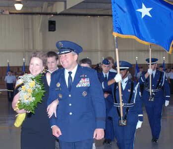 Brig. Gen. Gregory Feest, and his wife, Bridget, say goodbye to the crowd after taking command of 19th Air Force from Maj. Gen. Irving Halter in a change of command ceremony July 30 in Hangar 4 at Randolph Air Force Base, Texas. (U.S. Air Force photo by Rich McFadden)