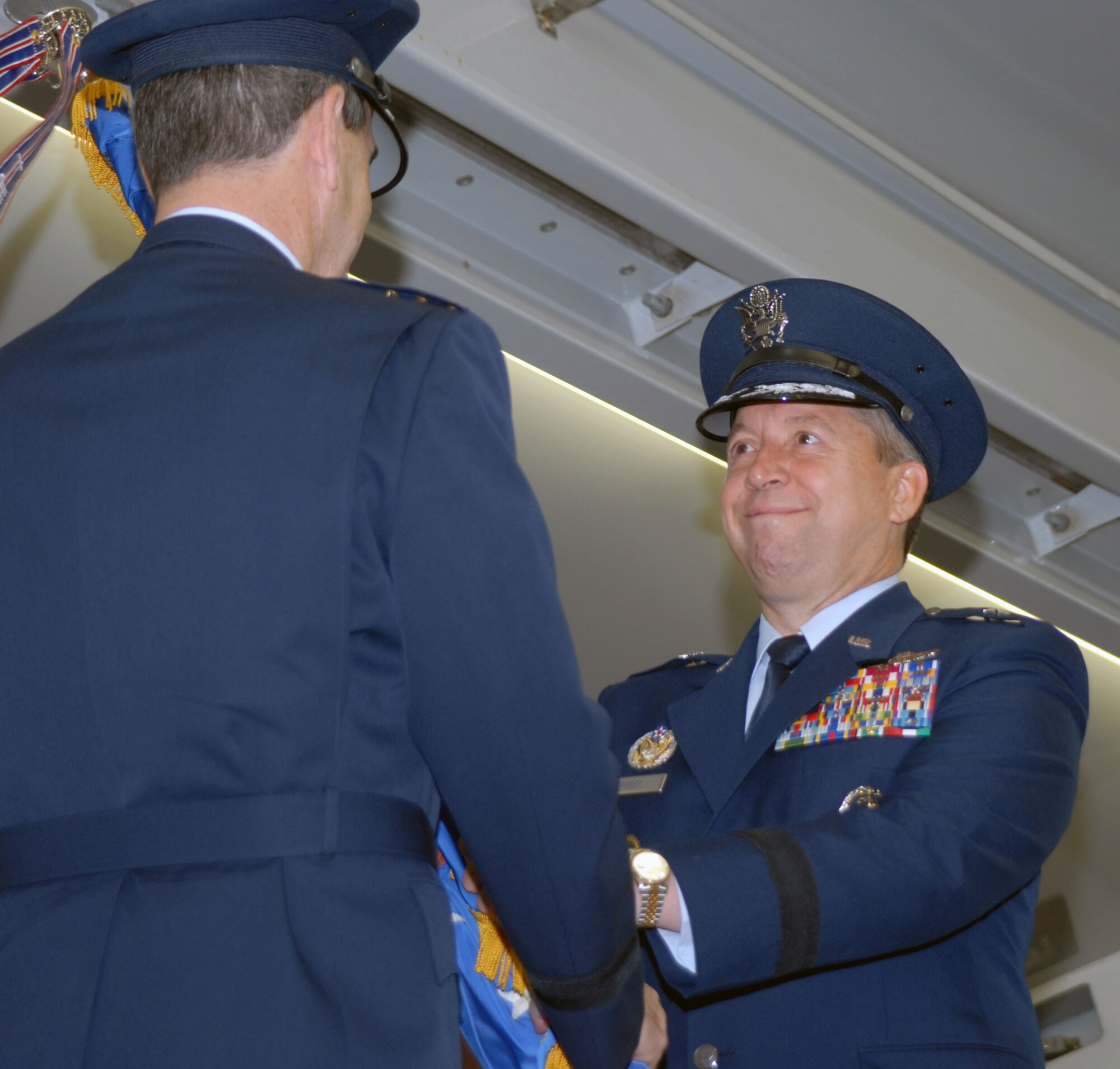 Brig. Gen. Gregory Feest takes command of 19th Air Force from Gen. Stephen Lorenz, Air Education and Training Command commander, during a change of command ceremony July 30 in Hangar 4 at Randolph Air Force Base, Texas. (U.S. Air Force photo by Rich McFadden)