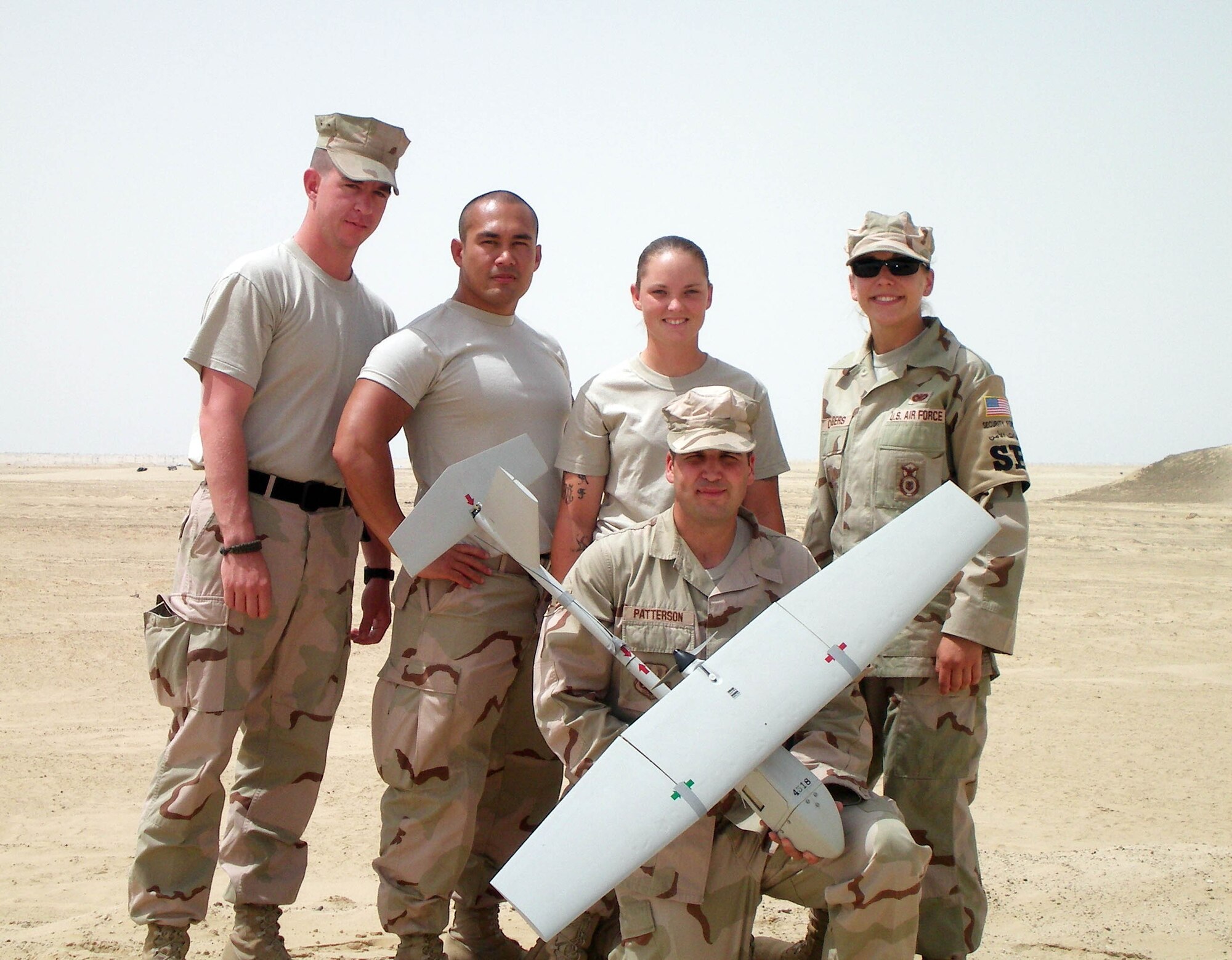 The team from the 71st Security Forces Squadron at Vance AFB, Okla., was the first from Air Education and Training Command to successfully use the Raven unmanned aircraft system operationally. They are, standing from left, Airman 1st Class William Ritchey, Tech. Sgt. Joseph Gonzales, Airman 1st Class Kaleigh Land and Staff Sgt. Jennifer Chambers. Holding the Raven is Senior Airman Sean Patterson.  (Courtesy photo)