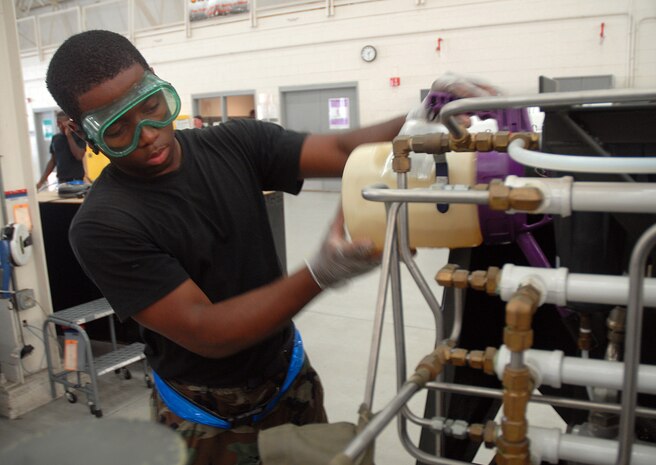 Airman 1st Class Adrian Bozeman adds oil to a self-generating nitrogen servicing cart during a yearly inspection July 30.  The 437th Maintenance Squadron Aerospace Ground Equipment Flight?s inventory includes more than 490 pieces of equipment that support Charleston AFB flightline operations.  Airman Bozeman is an AGE apprentice with the 437 MXS. (U.S. Air Force photo/Staff Sgt. Jennifer Arredondo) 