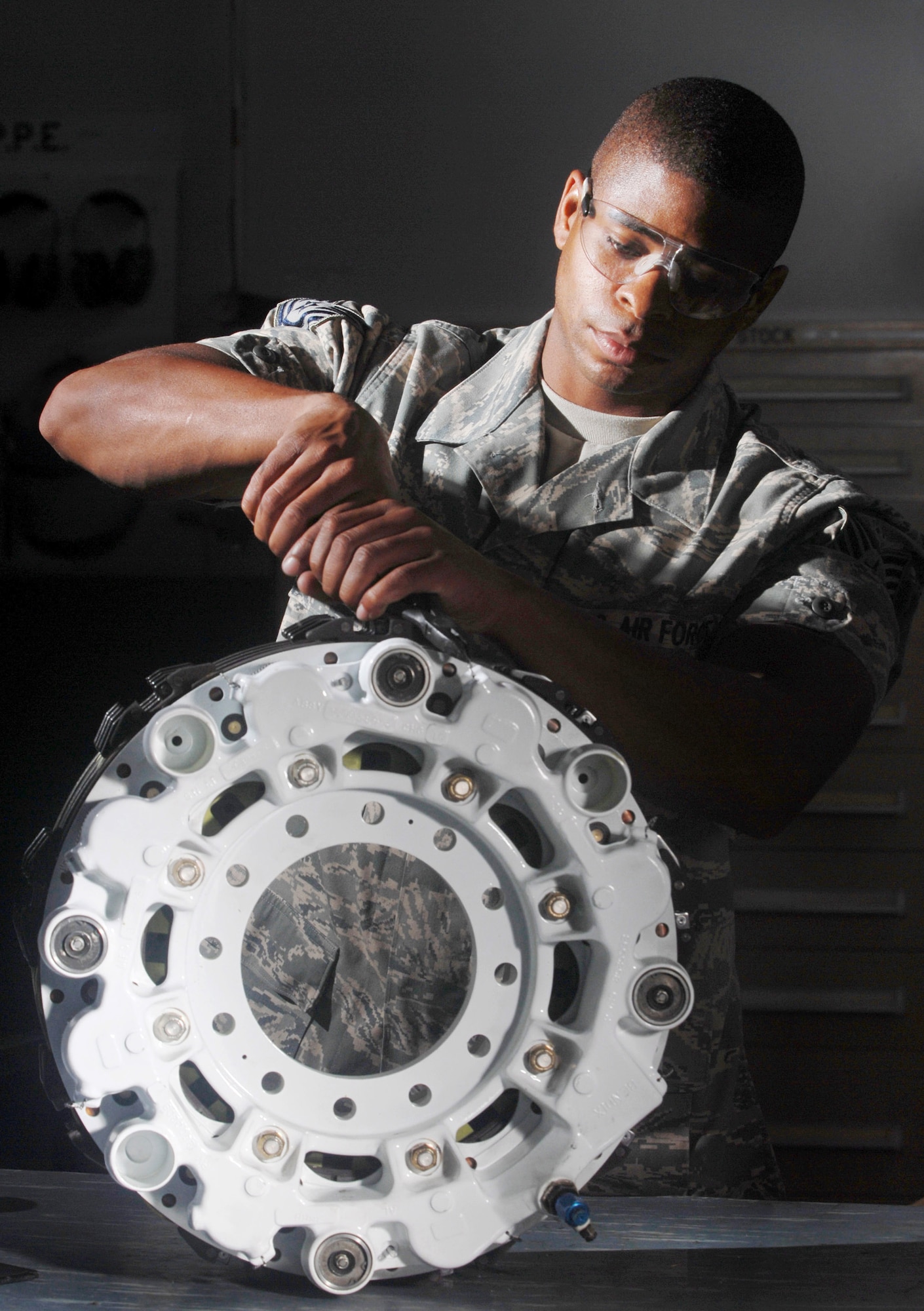 Tech. Sgt. Alan L. Scott uses a pair of pliers to attach safety wire to pistons on KC-135 Stratotanker refueling aircraft brake assembly July 30 at March Air Reserve Base, Calif.  March ARB, located in Southern California, is home to the largest air mobility wing in the Air Force Reserve Command. It is also home to units from the Army Reserve, Navy Reserve, Marine Corps Reserve and Air National Guard.  Sergeant Scott is a pneudraulics technician from the 452nd Maintenance Squadron. (U.S. Air Force photo/Val Gempis)