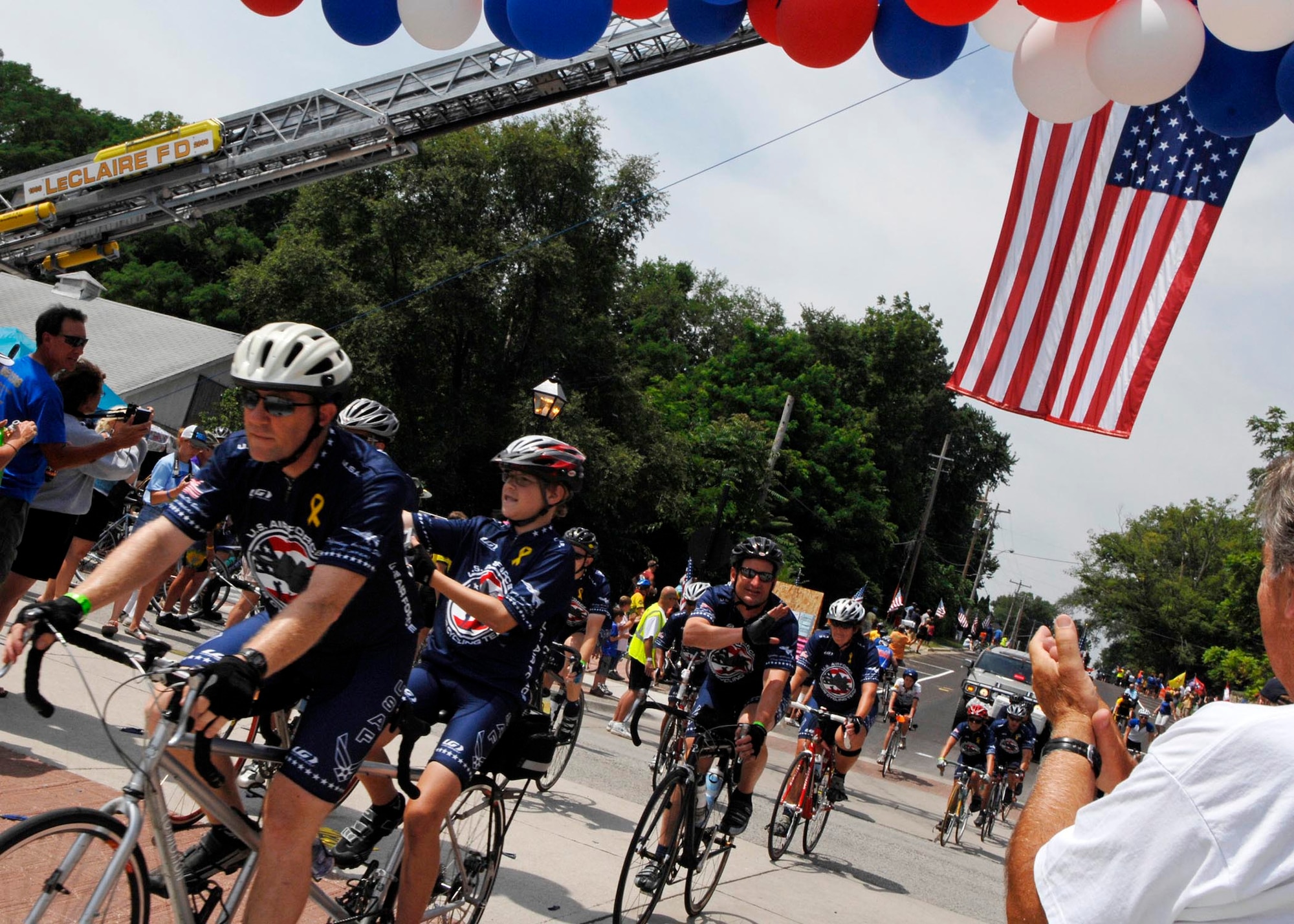 LE CLAIRE, Iowa - Members of the Air Force Cycling Team ride through cheering crowds of cyclists and Iowa natives at the completion of the Registers Annual Great Bike Ride Across Iowa, July 26. The AFCT has been participating in the RAGBRAI for the past 14 years to boost recruiting in Iowa, and to promote fit to fight. (U.S. Air Force photo by Airman 1st Class Joanna M. Kresge)