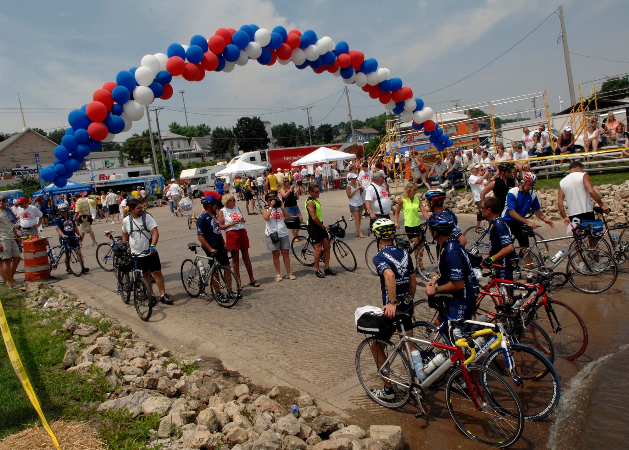 LE CLAIRE, Iowa - Members of the Air Force Cycling Team pose for a photo while dipping their front tire in the Mississippi River, July 26. Tradition dictates that upon completion of the Registers Annual Great Bike Ride Across Iowa, participants dip their front tire in the river to symbolize their journey from one end of the state to the other. (U.S. Air Force photo by Airman 1st Class Joanna M. Kresge)