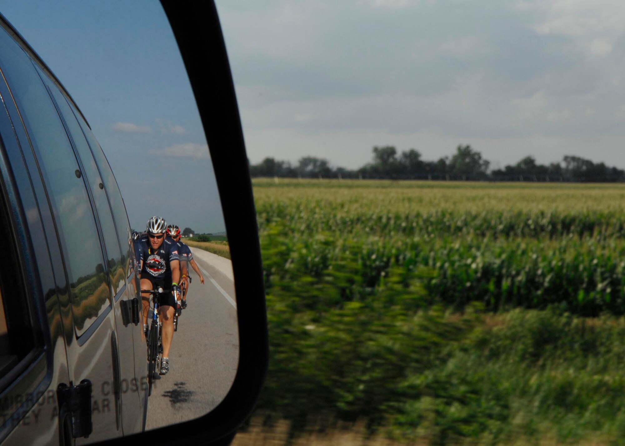 MISSOURI VALLEY, Iowa - Members of the Barksdale Air Force Base  Cycling Team ride their bikes across Iowa countryside after dipping their rear wheel in the Missouri River during the Registers Annual Great Bike Ride Across Iowa July 19. The RAGBRAI travels from west to east through the state, and tradition dictates riders dip their rear tire in the Missouri River, and front tire in the Mississippi River upon completion of the event, seven days later. (U.S. Air Force photo by Airman 1st Class Joanna M. Kresge)