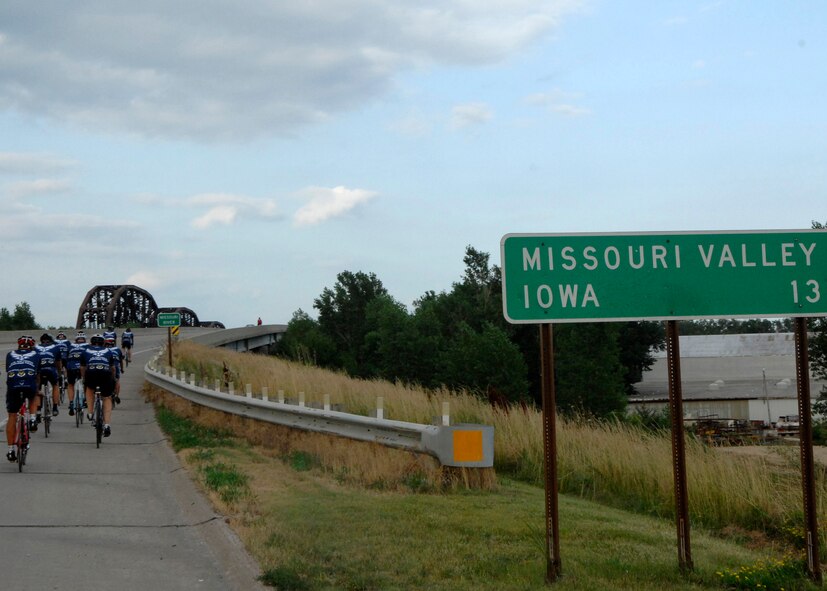 MISSOURI VALLEY, Iowa - Members of the Barksdale Air Force Base Cycling Team ride their bikes across the Missouri River after dipping their rear wheel in the river during the Registers Annual Great Bike Ride Across Iowa July 19. The RAGBRAI travels from west to east through the state, and tradition dictates riders dip their rear tire in the Missouri River, and front tire in the Mississippi River upon completion of the event, seven days later. (U.S. Air Force photo by Airman 1st Class Joanna M. Kresge)