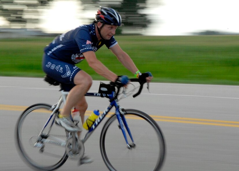 MISSOURI VALLEY, Iowa -- Master Sgt Alex Wilkins rides his bike back to his campsite after dipping his rear tire in the Missouri River, July 19. The RAGBRAI travels from west to east through the state, and tradition dictates riders dip their rear tire in the Missouri River, and front tire in the Mississippi River upon completion of the event, seven days later. (U.S. Air Force photo by Airman 1st Class Joanna M. Kresge) (Released)