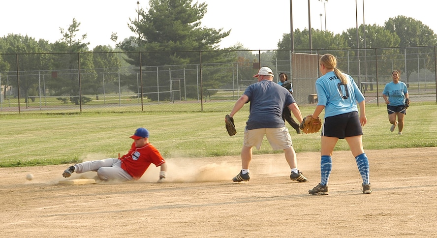 AFOSI Gators’ Jeff Hemphill slides safely into second after a base hit. Hemphill later took third base on an errant throw by the 79th MED Group. In a pitcher’s duel in the early innings the Gators finally broke through in the fifth eventually taking the game 9-1. (U.S. Air Force photo/Tech. Sgt John Jung)