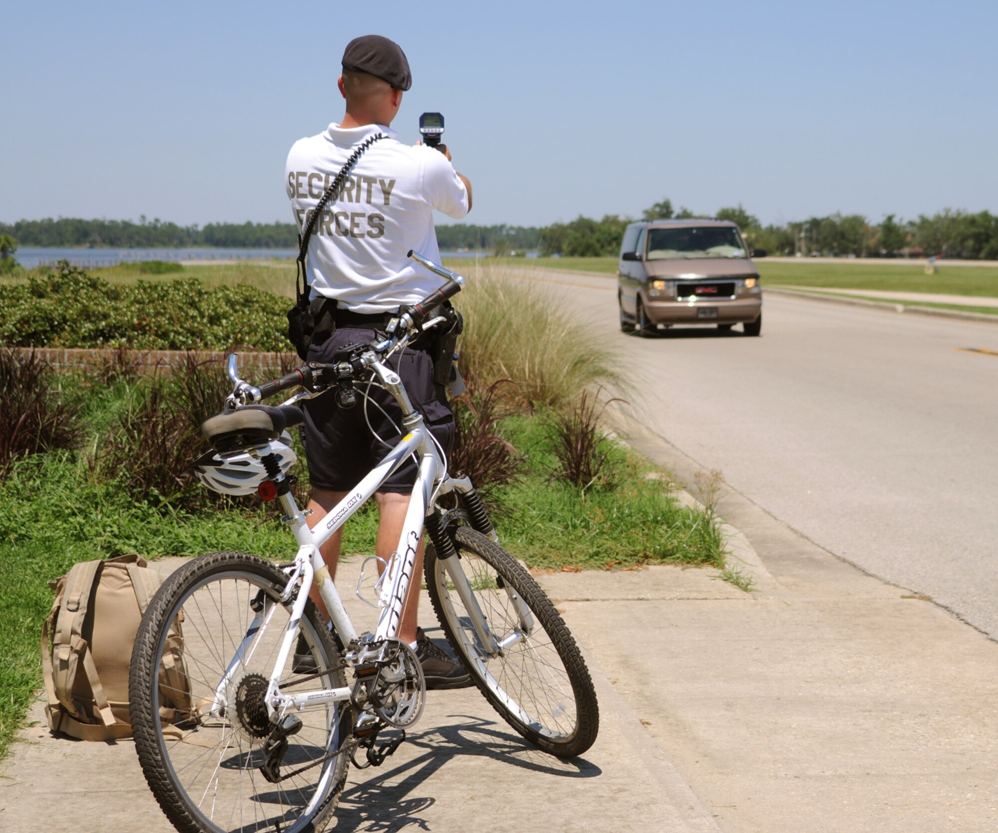Staff Sgt. Casey Sims uses a radar to check vehicle speeds on Ploesti Drive, July 15.  (U.S. Air Force photo by Kemberly Groue)