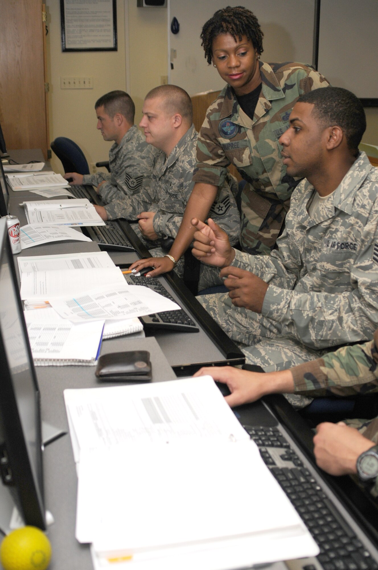 From left, Tech. Sgt. Gary Romkey and Staff Sgt. Brandin Coy, 335th Training Squadron; Tech. Sgt. Shuntesia Dupree, 81st Training Support Squadron instructor; and Staff Sgt. Joe Perry, 85th Engineering Installation Squadron, cover the basics of the Technical Training Management System that’s used by instructors for student accounting.  (U.S. Air Force photo by Kemberly Groue)