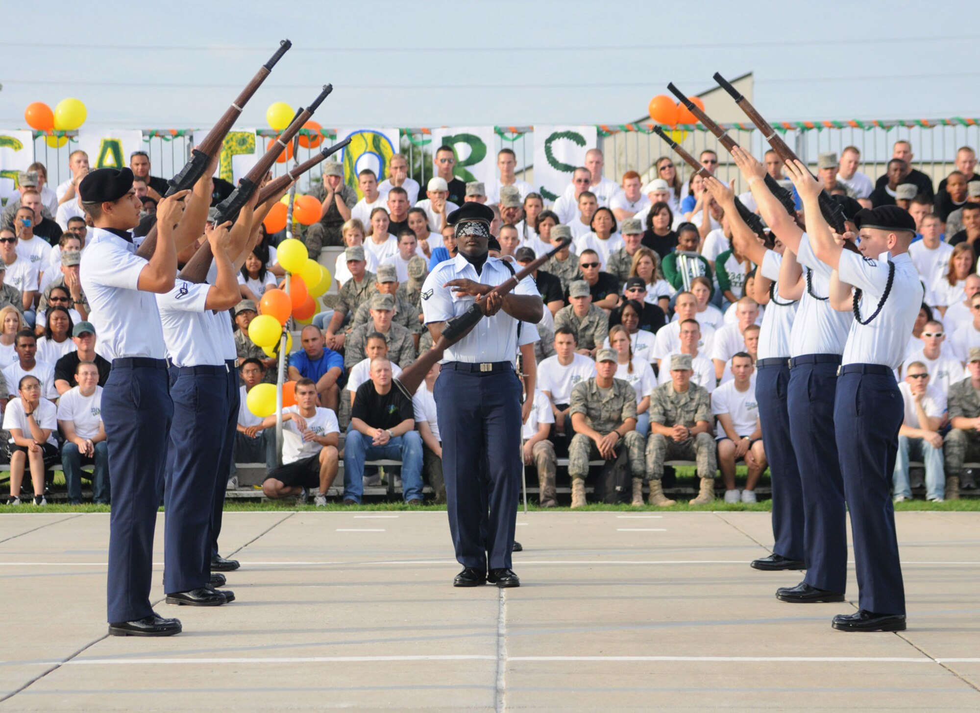 Airman 1st Class Shomari Davis, blindfolded, twirls a rifle during the freestyle competition.  The Red Wolves won this category and regulation drill to earn overall honors.  (U.S. Air Force photo by Kemberly Groue)