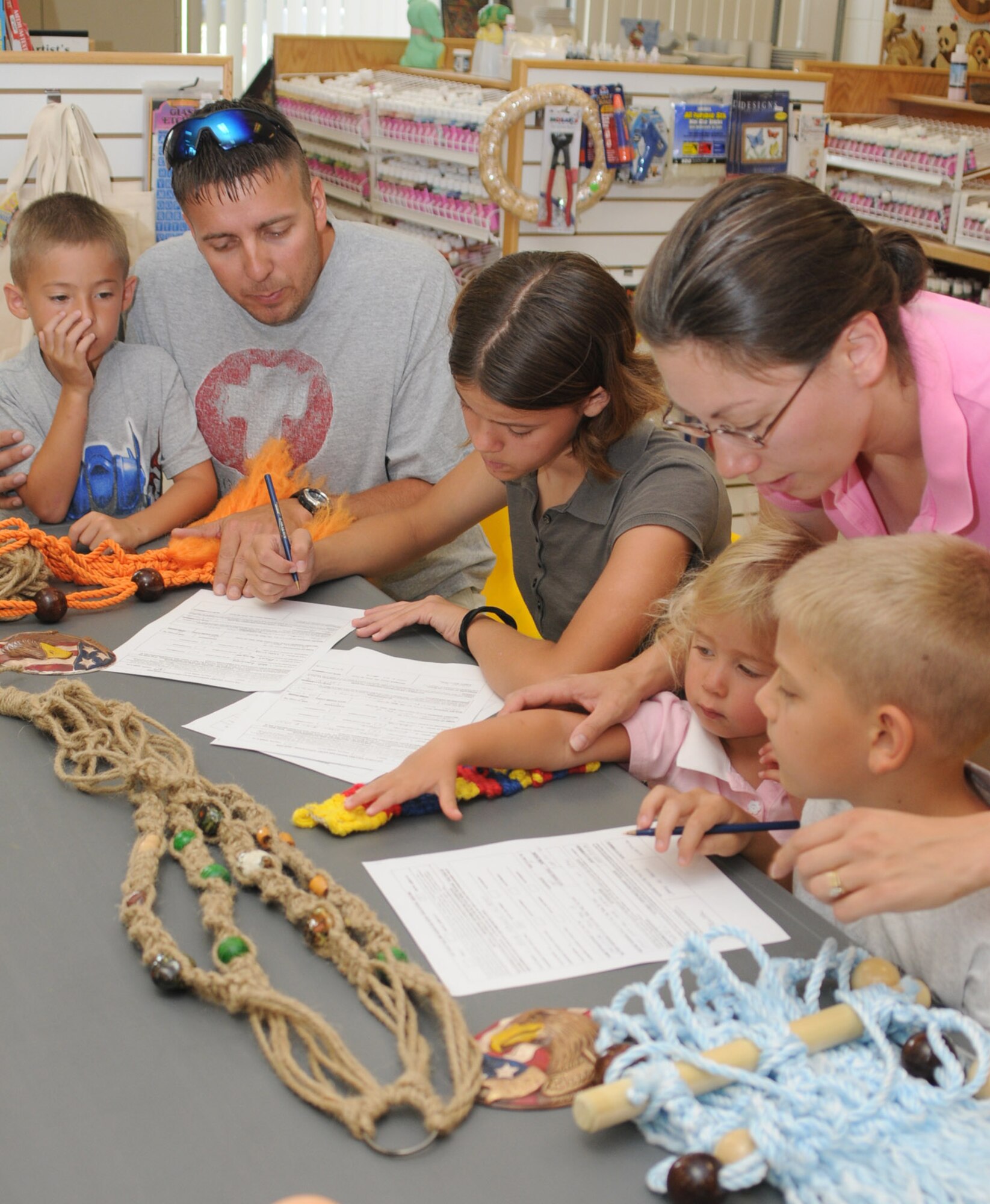 The Christian family completes forms for youth entries for the Air Force gallery.  From left are Tyler, 5; Tech. Sgt. Allen Christian, 338th Training Squadron; Alexis, 12; Tech. Sgt. Anna Christian, 81st Supply-Transportation Squadron; Madison, 2; and Hunter, 9.  (U.S. Air Force photo by Kemberly Groue)