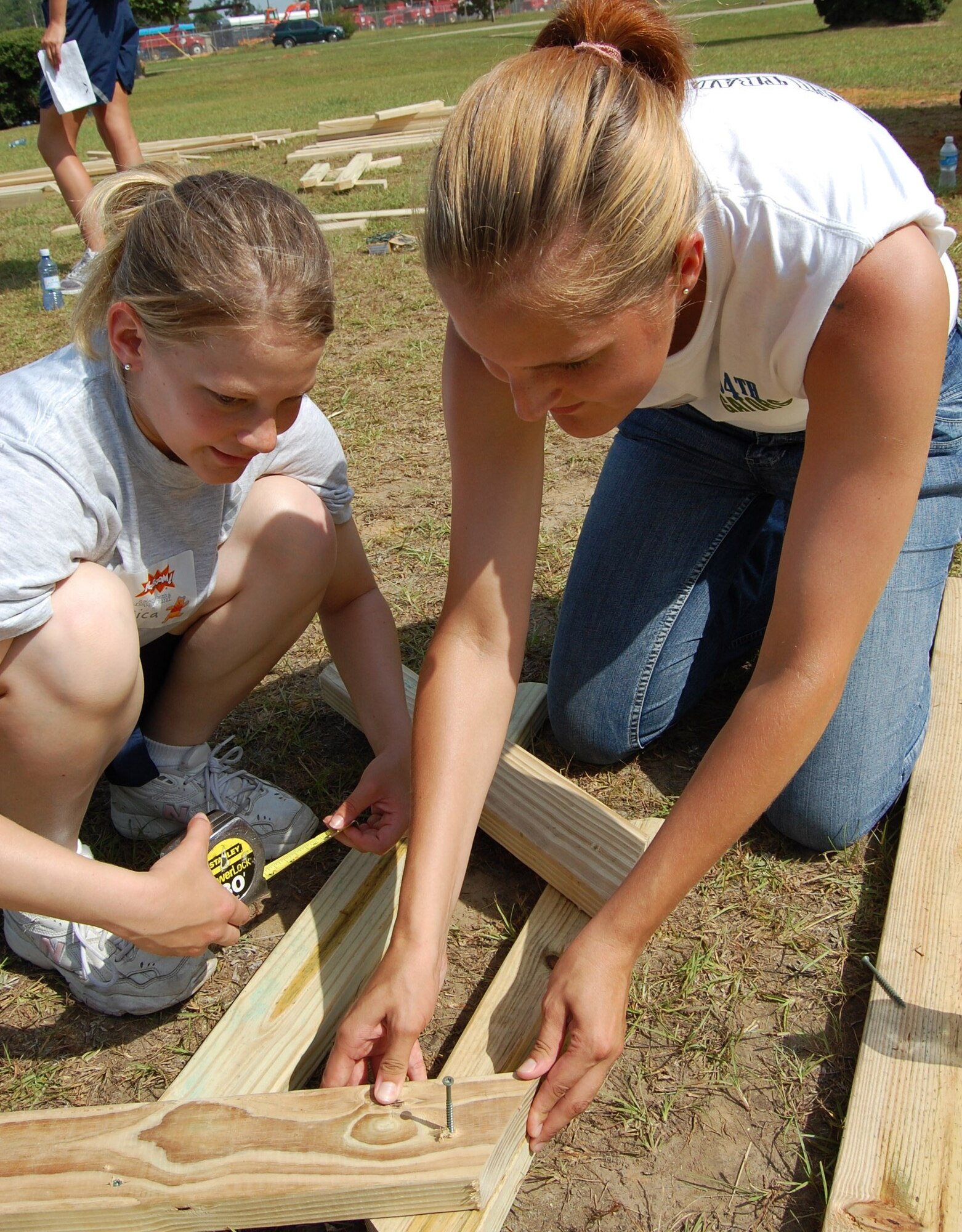 Airman 1st Class Jessica Davis and Airman Donna Full, right, work on KABOOM playground construction Saturday near the Wool-market Community Center.  More than 200 Keesler volunteers from the 81st Medical Support Squadron and 334th and 335th Training Squadrons joined other community members of the local community in the project.  Airman Davis is from the 335th TRS and Airman Full is from the 334th TRS.

