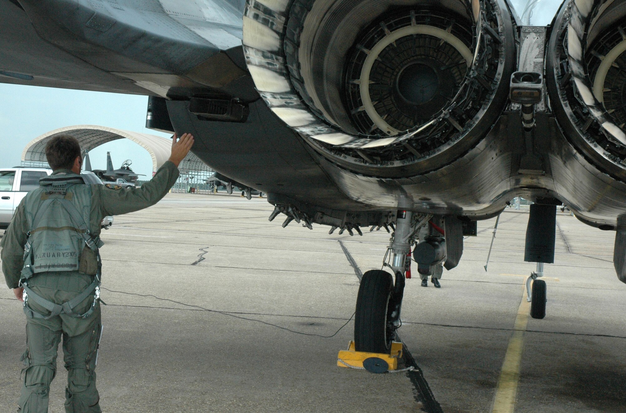 EGLIN AIR FORCE BASE, Fla. -- A pilot from the 422nd Test and Evaluation Squadron "Steps" or performs his pre-flight inspection of the F-15 aircraft he will be flying for the Bold Quest Plus demonstration. A-10s, F-15s amd F-16s from the 422nd Test and Evaluation Squadron and 132 personnel were brought in by the 53rd Wing to help the internation Bold Quest players demonstrat and evaluate new equipment. (US Air Force photo/ Airman 1st Class Anthony Jennings)