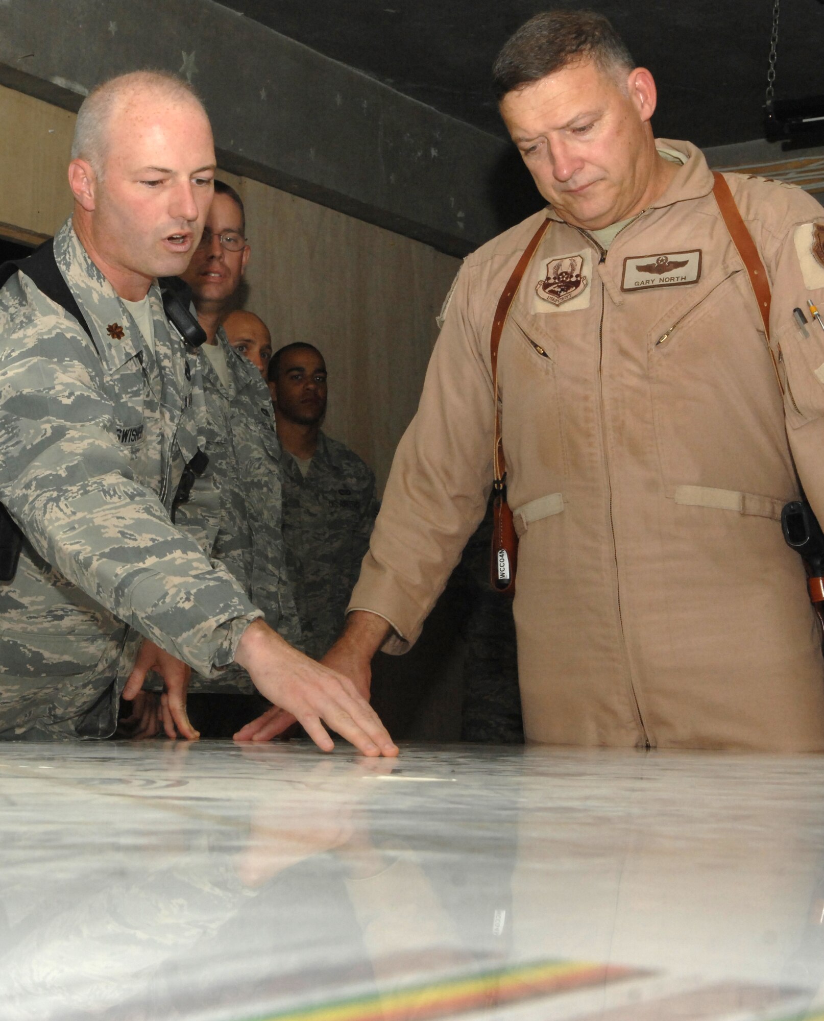 KIRKUK REGIONAL AIR BASE, Iraq -- Maj. Kevin Swisher, 506th Expeditionary Civil Engineer Squadron Engineering shop flight commander, briefs Lt. Gen. Gary L. North, 9th Air Force and U.S. Air Forces Central commander, on the projects going on around the installation July 29.  506 ECES currently has 40 active projects worth a total of $28 million. Maj. Swisher is deployed from Pittsburg Air Reserve Station, Pa. and calls Morgantown, W.V. home. (U.S. Air Force photo/Senior Airman Randi Flaugh)