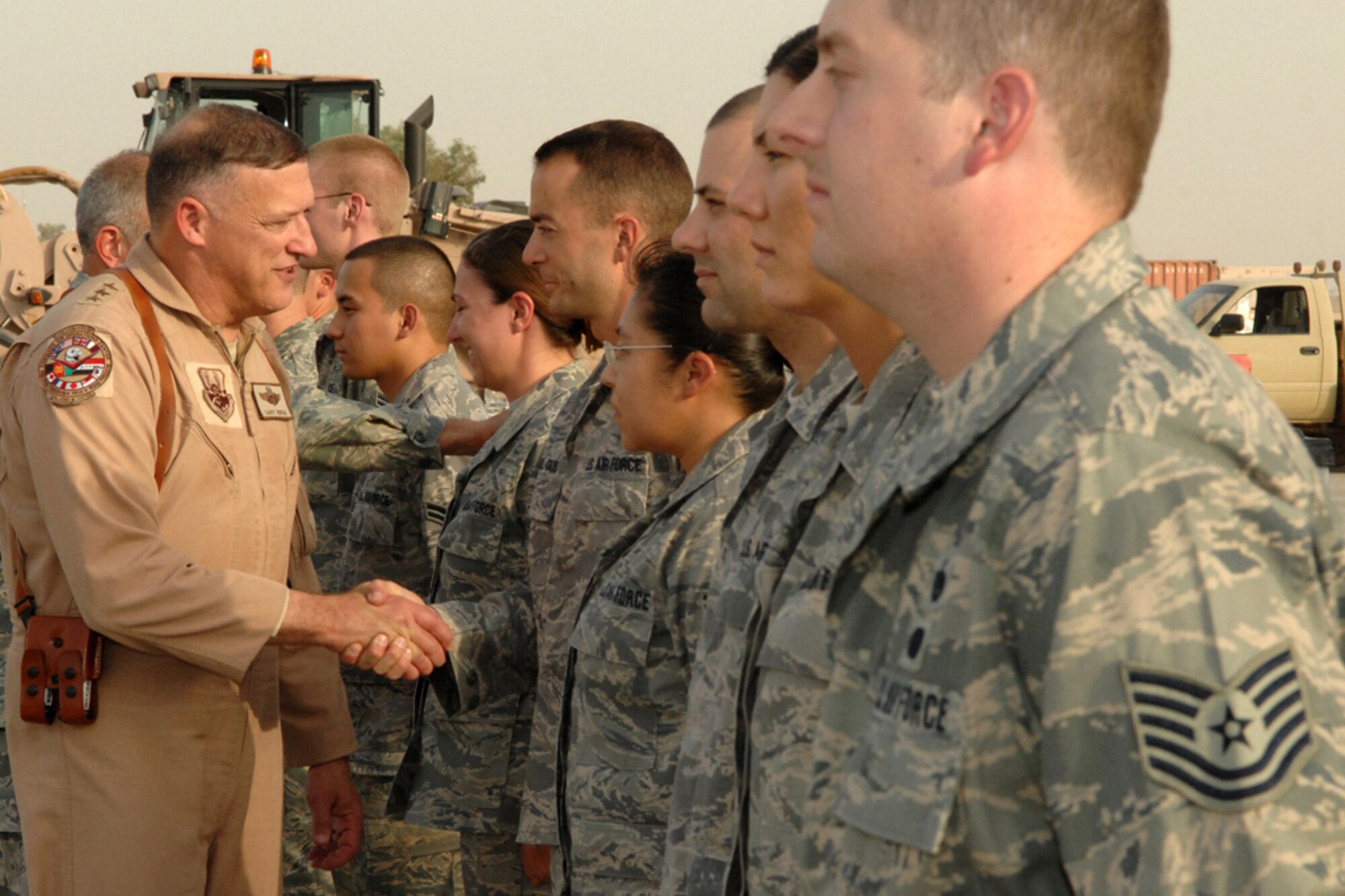 KIRKUK REGIONAL AIR BASE, Iraq -- Lt. Gen. Gary L. North, 9th Air Force and U.S. Air Forces Central commander, greets Airmen from the 506th Expeditionary Logistics Readiness Squadron, during his visit here July 29.  Gen. North is visiting installations around the area of responsibility before returning to Shaw Air Force Base, S.C. (U.S. Air Force photo/Senior Airman Randi Flaugh)
