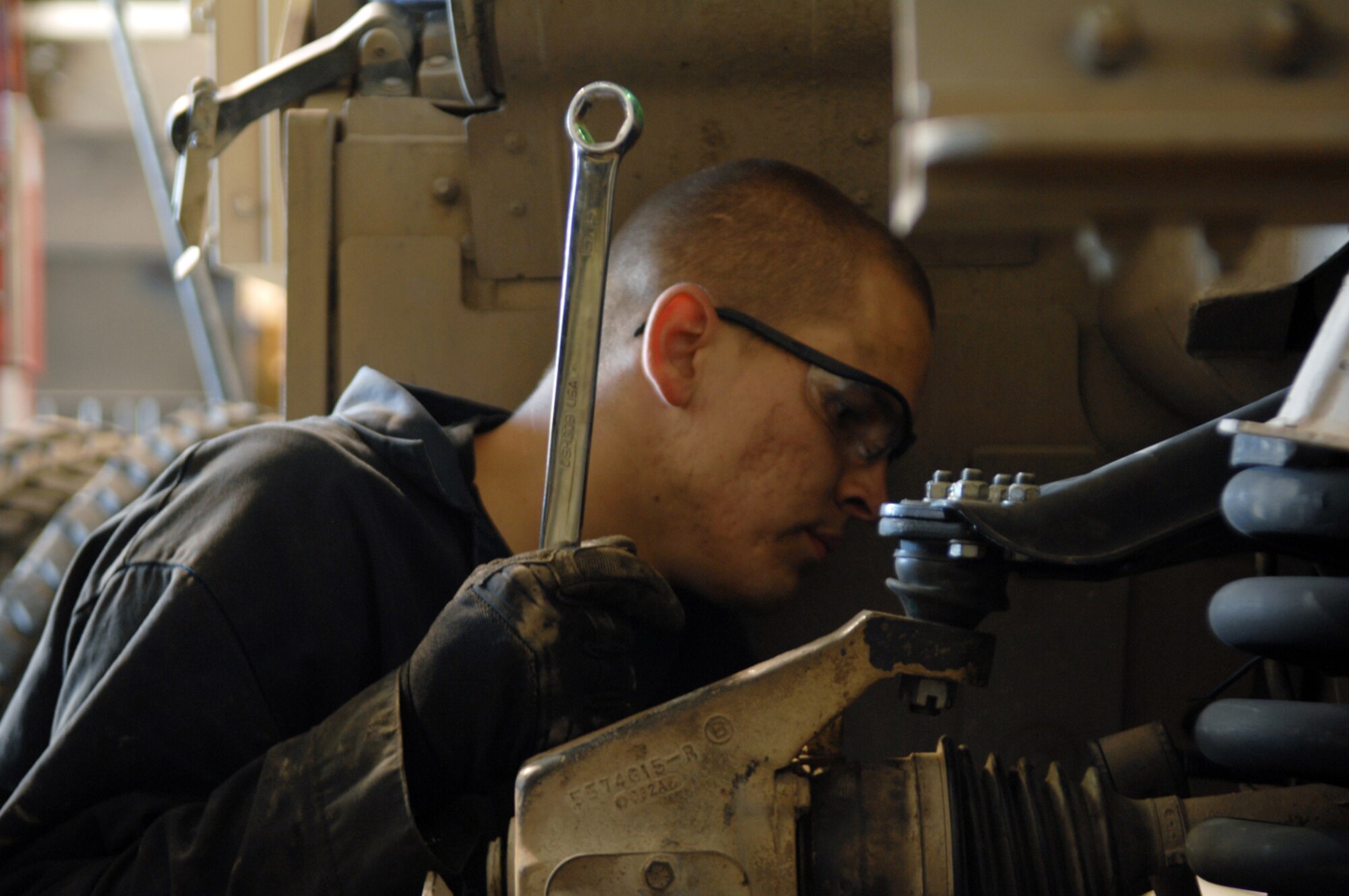MANAS AIR BASE, KYRGYZ REPUBLIC -- Senior Airman Ryan Zitnick, 376th Air Expeditionary Wing Vehicle Maintenance mechanic, installs a suspension upgrade to a HUMVEE. The vehicle maintenance flight employees the efforts of 28 mechanics just like Airman Zitnick to keep Manas' fleet of more than 350 vehicle operating daily. (Air Force photo / Tech. Sgt. Michael Voss)