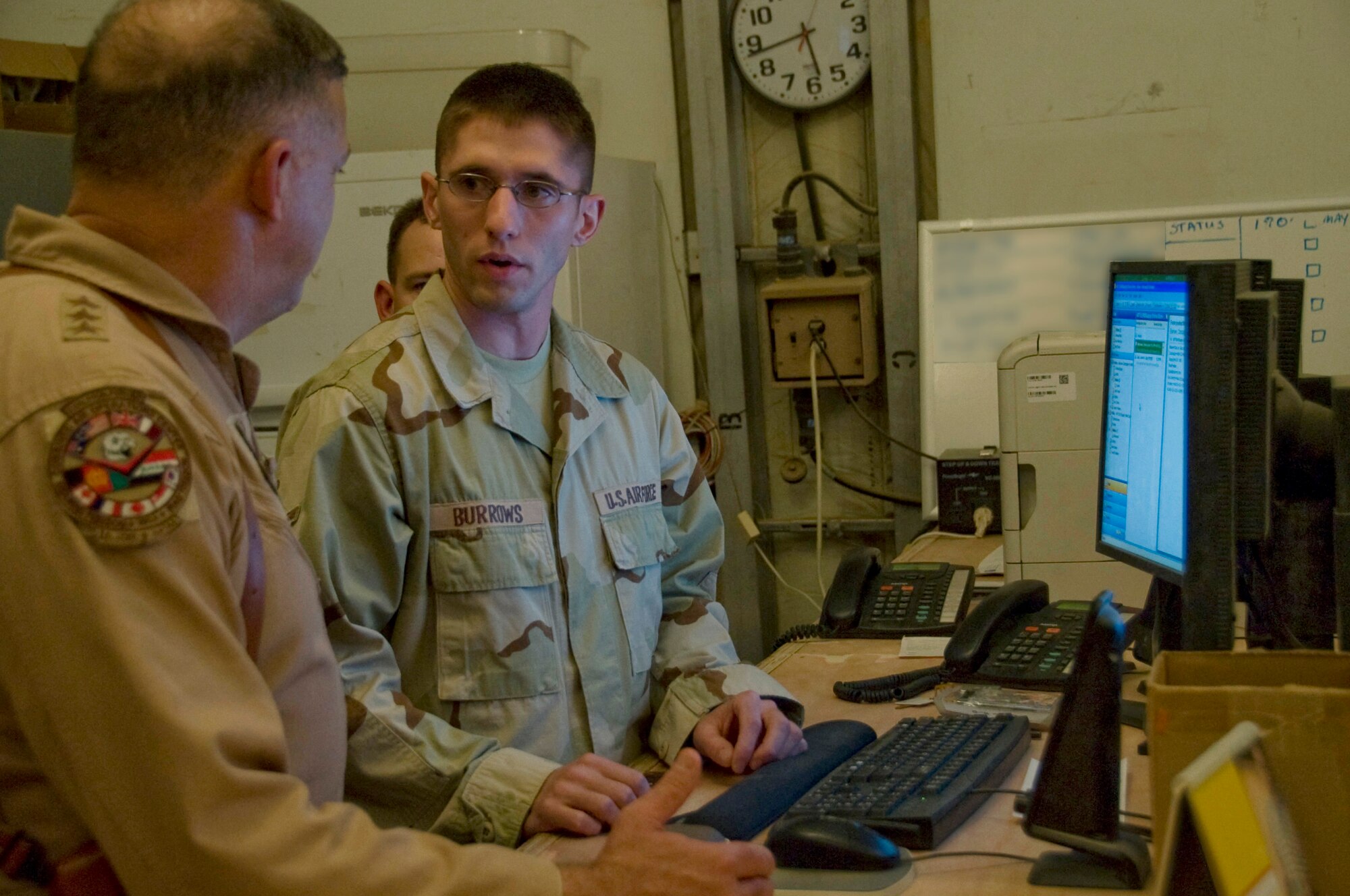 ALI BASE, Iraq -- Airman Christopher Burrows, 407th Expeditionary Logistics Readiness Squadron, explains to Lt. Gen. Gary North, U.S. Air Forces Central and 9th Air Force commander, a process used by the supply unit here that makes workflow more fluid. General North, along with Chief Master Sgt. Scott Dearduff, USAFCENT command chief master sergeant, stopped here July 28, 2008 to see recent improvements and to thank Airmen for their service to their country. Airman Burrows is deployed from Ellsworth Air Force Base, S.D. (U.S. Air Force photo/Airman 1st Class Christopher Griffin)