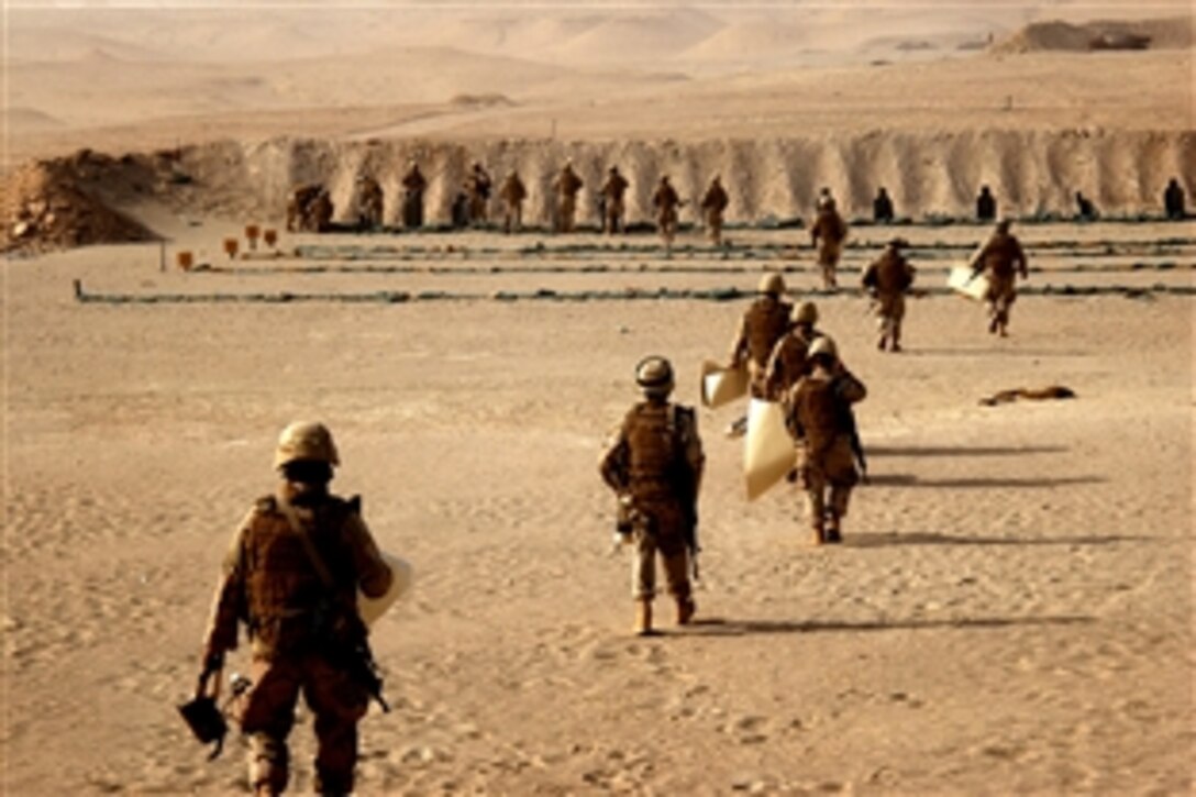 U.S. Navy Seabees walk down to the Joe Foss range during weapons training in Taqaddum, Iraq, July 27, 2008. The Seabees, assigned to a mobile construction battalion, are on a six-month deployment to Iraq to provide general engineering support to coalition forces. 
