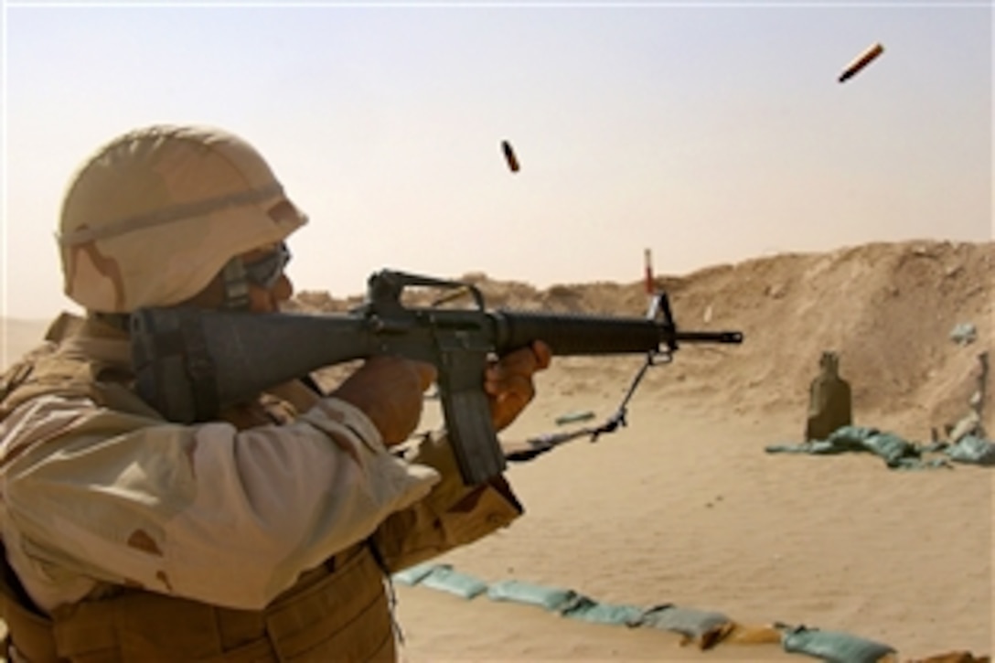 U.S. Navy Petty Officer 2nd Class Jason Maxwell fires an M-16 using a three-round burst at the Joe Foss range during a weapons training in Taqaddum, Iraq, July 27, 2008. The Seabees, assigned to a mobile construction battalion, are on a six-month deployment to Iraq to provide general engineering support to coalition forces. 
