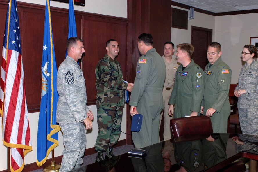 Tech. Sgt. Casey L. Carden is congratulated by 15th Airlft Wing members after receiving a Navy Achievement Medal for his work during the RIMPAC 2008 exercise. (U.S. Air Force Photo/Oscar A. Hernandez)