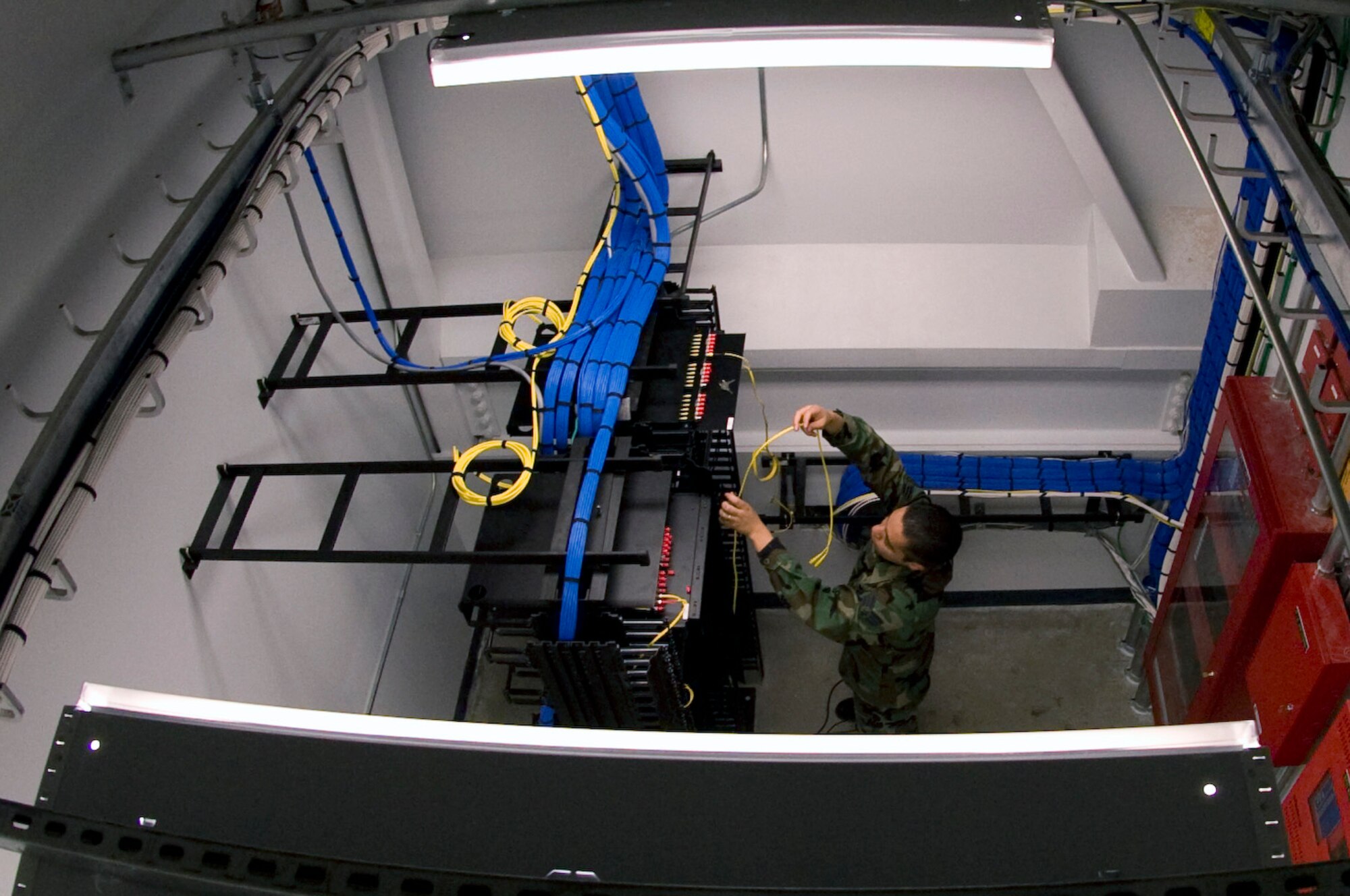 Senior Airman Ricardo Soto connects fiber optic cables to a foundry switch in the new fitness center addition July 31, 2008, at Eielson Air Force Base, Alaska. Once installed, the switch will provide local area network connectivity for the Health And Wellness Center computers which will enable them access to internet, e-mail and base networks. Airman Soto is a network infrastructure technician assigned to the 354th Communication Squadron. (U.S. Air Force photo by Airman 1st Class Jonathan Snyder) (Released)