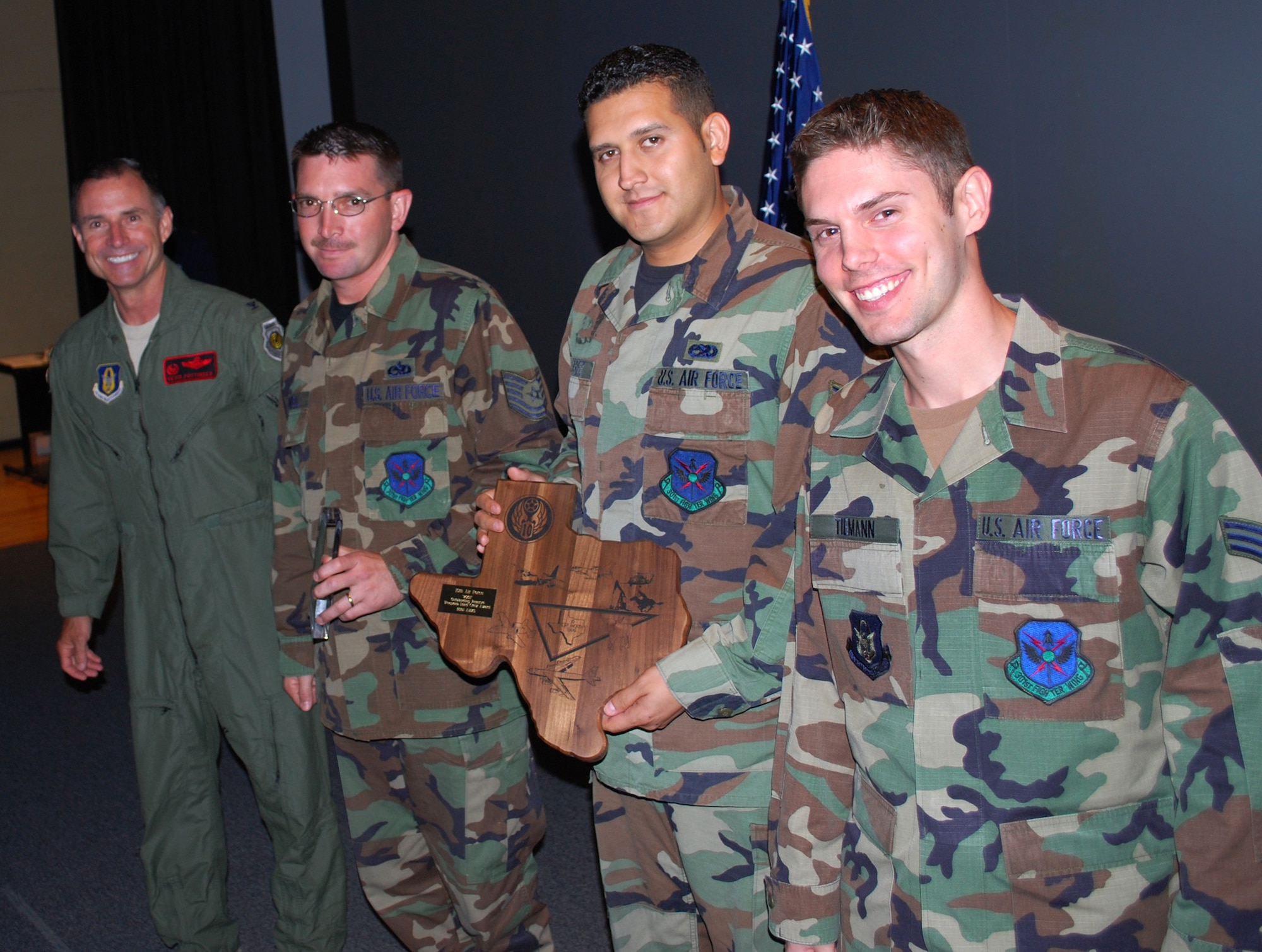 Col. Kevin Pottinger, 301st Fighter Wing commander, presented Air Force Reserve Command-level awards to several Airmen during July's Unit Training Assembly 301st Maintenance Group commander's call.  Recipients of this AFRC prestigious award were: Tech. Sgt. Bobby Powell, Senior Airman Sidonio Suarez, and Senior Airman Christopher Tieman who were also honored with the 10th Air Force Load Crew of 2007 and Senior Master Sgt. Scott Jongewaard received the 10th AF Lt. Gen. Lew Allen 2007 award. (U.S. Air Force Photo/Tech. Sgt. Stephen Bailey)  
