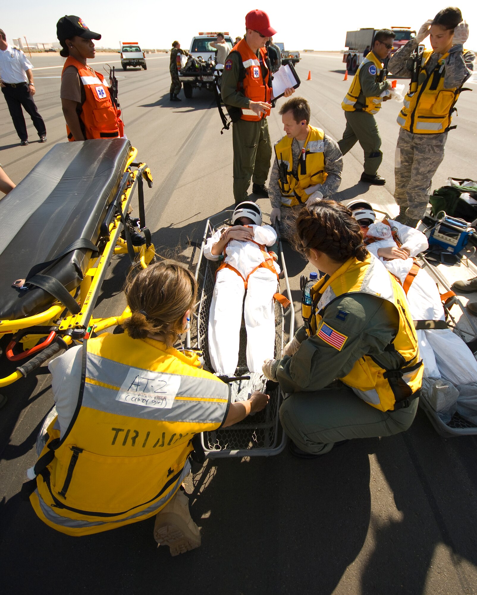 Military medics provide medical care to crewmembers after a simulated space shuttle crash during an emergency response exercise here July 26. The exercise tested the base's emergency response capabilities to an emergency shuttle landing. (Air Force photo by Mike Cassidy) 