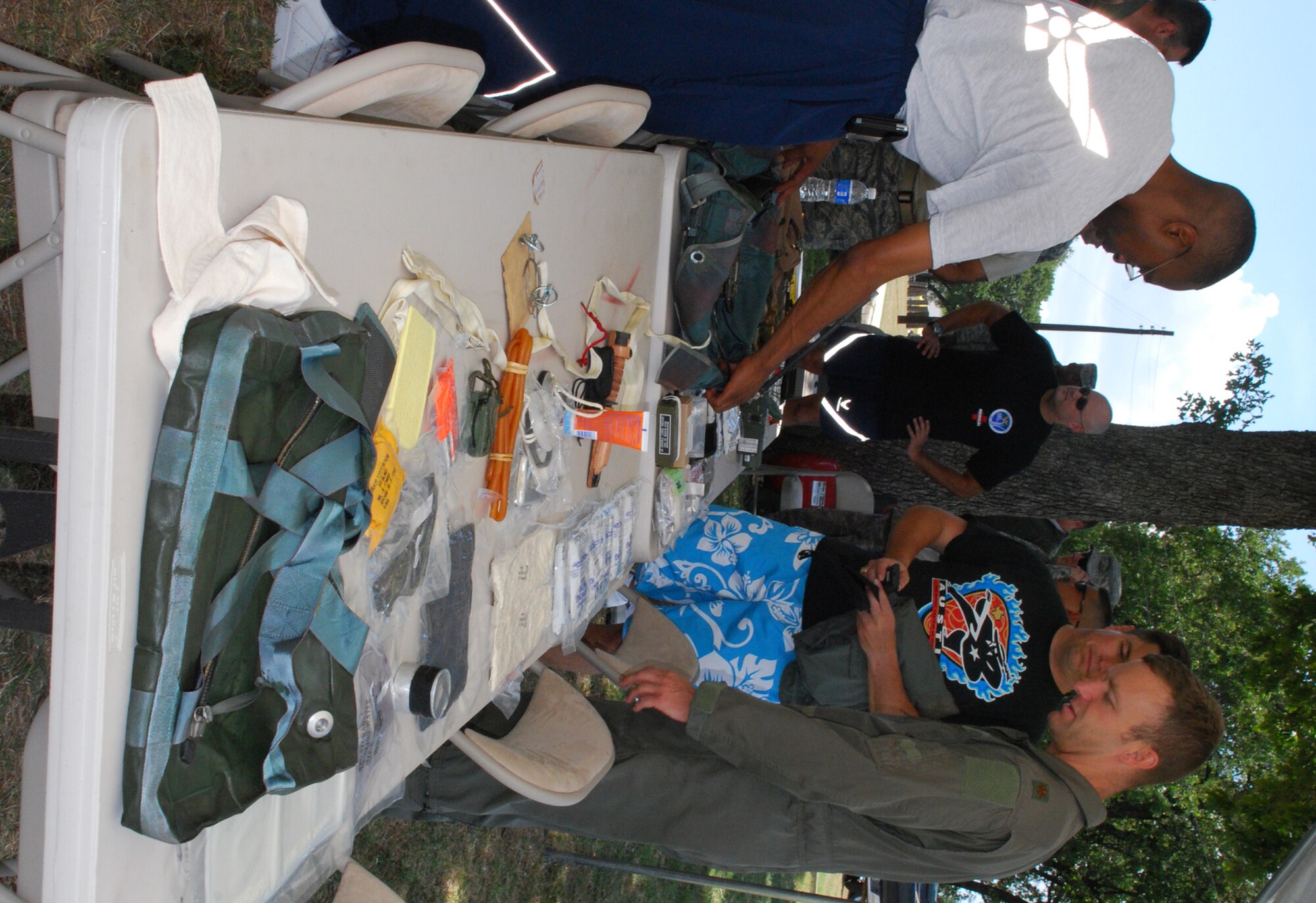 Pilots from the 457th Fighter Squadron recently endured their annual water survival training conducted at Lake Worth in Fort Worth, Texas. Tech. Sgt. Drake Brown (left) life support technician, gives Maj. Stephen Nelson, F-16 pilot, a briefing on the contents of the survival pack he is supplied each time he flys. All pilots are required to recieve this annual training from the Life Support team members. (U.S. Air Force Photo/Tech. Sgt. Julie Briden-Garcia)