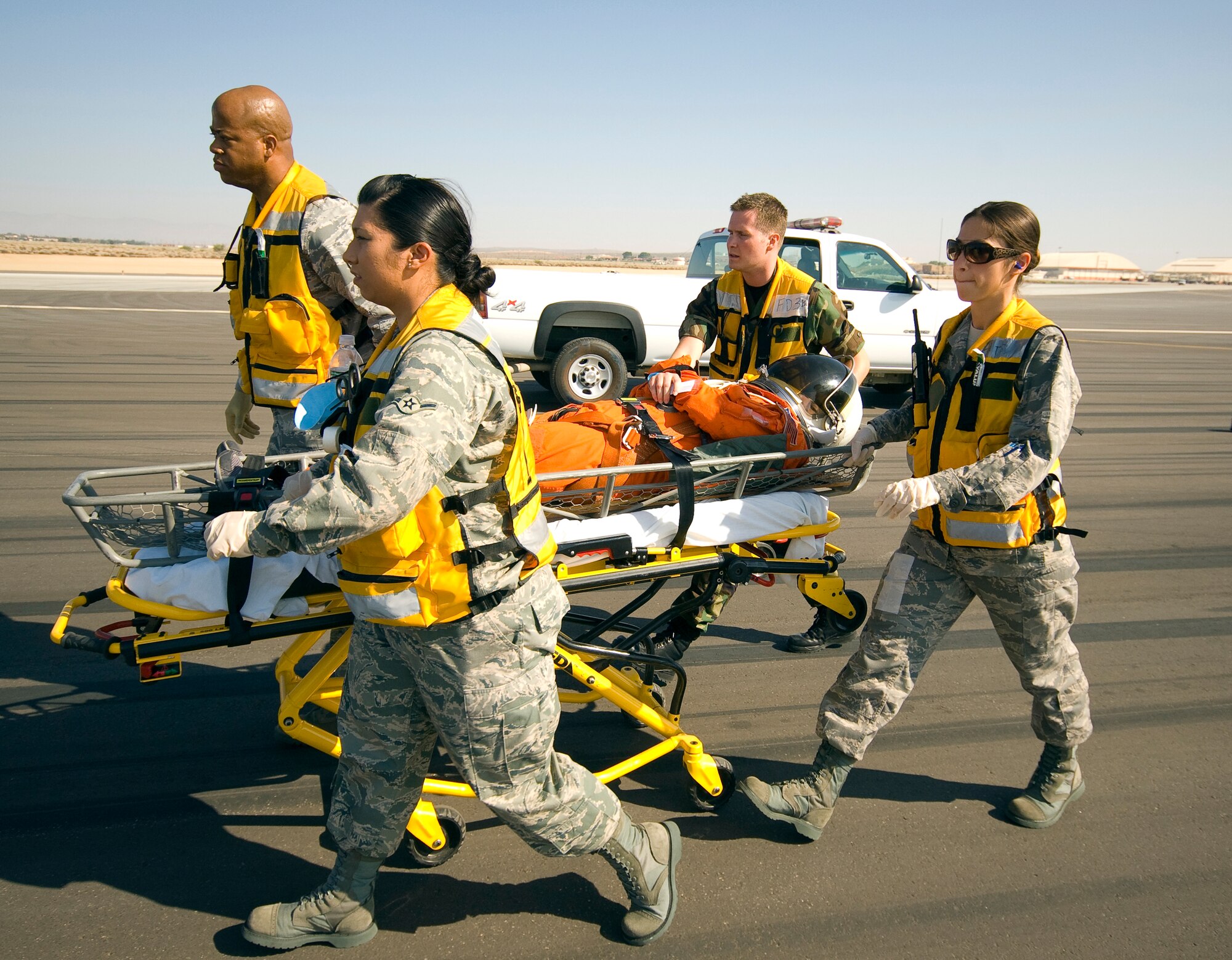 Team Edwards medical personnel transport an "astronaut" to a helicopter to be airlifted to a local hospital during a simulated space shuttle landing July 26. Fifty-one orbiters have landed at Edwards; the last one was space shuttle Atlantis on June 22, 2007. (Air Force photo by Mike Cassidy)