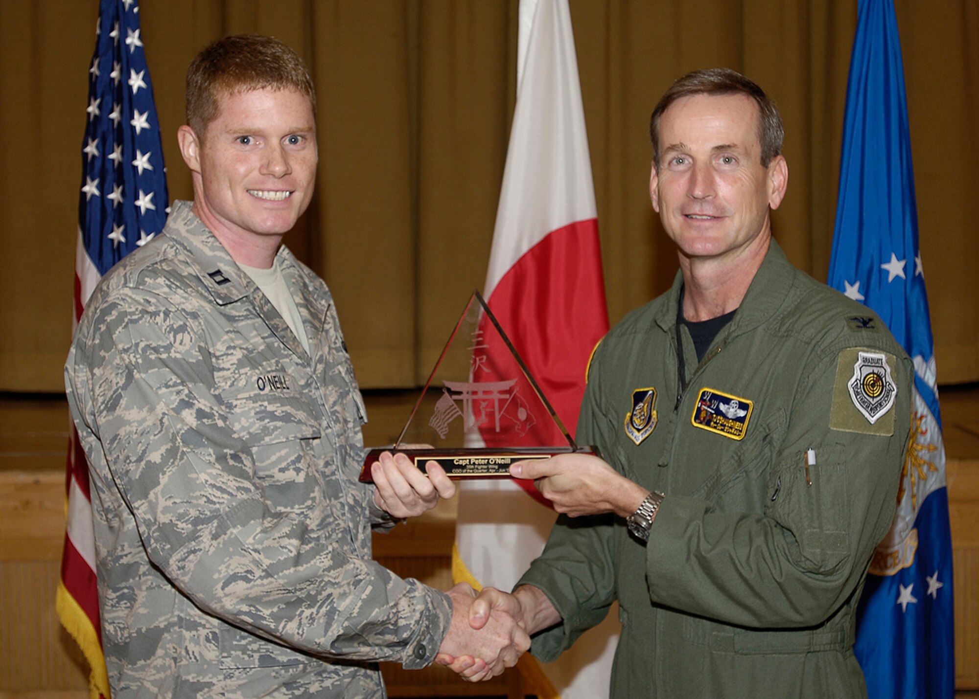 MISAWA AIR BASE, Japan -- Capt. Pete O'Neill, 35th Contracting Squadron, receives 35th Fighter Wing Company Grade Officer of the Quarter during the wing quarterly award luncheon July 25, 2008.  Captain O'Neill is a native of Baltimore, Md., and has been in the Air Force for seven years.  (U.S. Air Force photo by Senior Airman Chad Strohmeyer)

