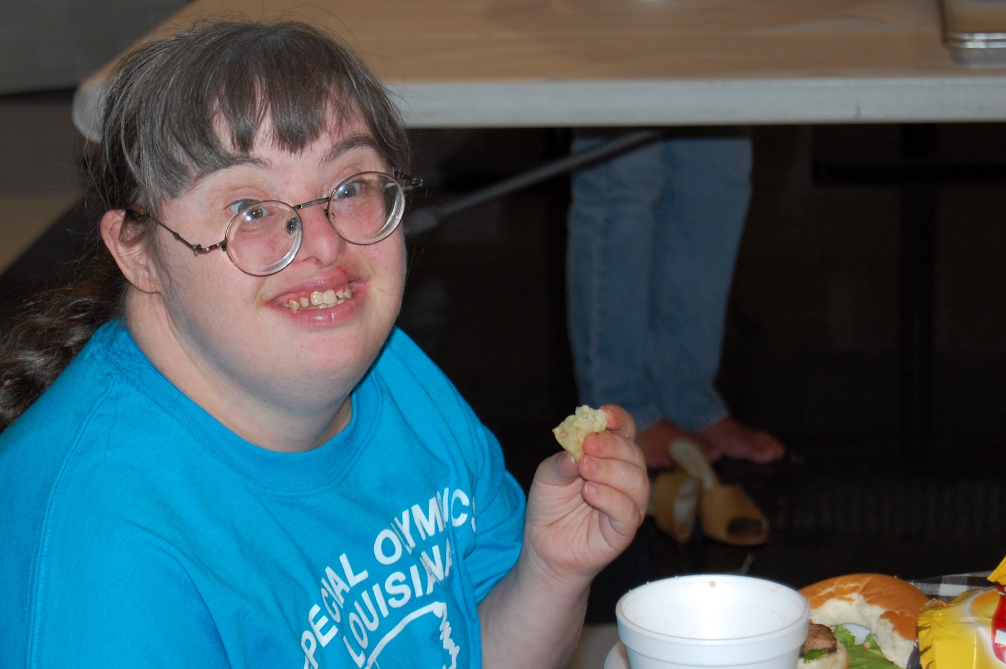 An athlete particpating in the Special Olympics Louisiana state unified bowling competition breaks for lunch. On July 26 more than 75 Airmen from Barksdale Air Force Base volunteered to help with the event held at the Holiday Inns bowling alley in Bossier City and a Special Olympic state swim competition at Louisiana State University in Shreveport. (U.S. Air Force photo/Senior Airman Brenda Skaggs) 
