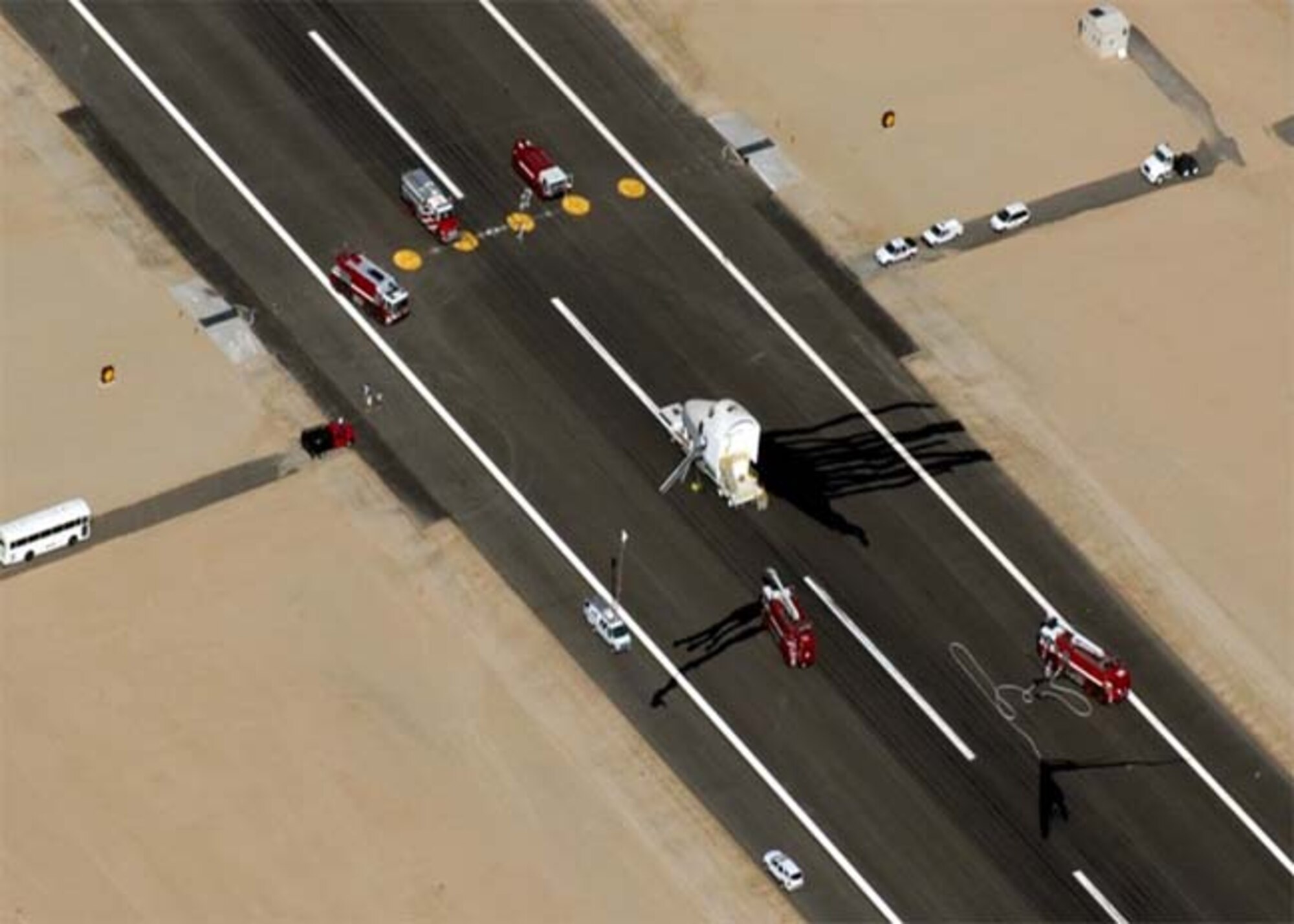 Team Edwards and the NASA Dryden Flight Research Center approach a space shuttle as part of an exercise July 26. Approximately 100 base and NASA personnel participated in the exercise. (Courtesy photo)