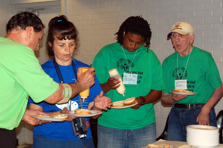 Volunteers and athletes take a lunch break together during the Special Olympics Louisiana state unified bowling competition held at the Holiday Inns bowling alley in Bossier City. On July 26 more than 75 Airmen turned out for the event which also consisted of a state swim competition held at Louisiana State University in Shreveport. (U.S. Air Force photo/Senior Airman Brenda Skaggs)