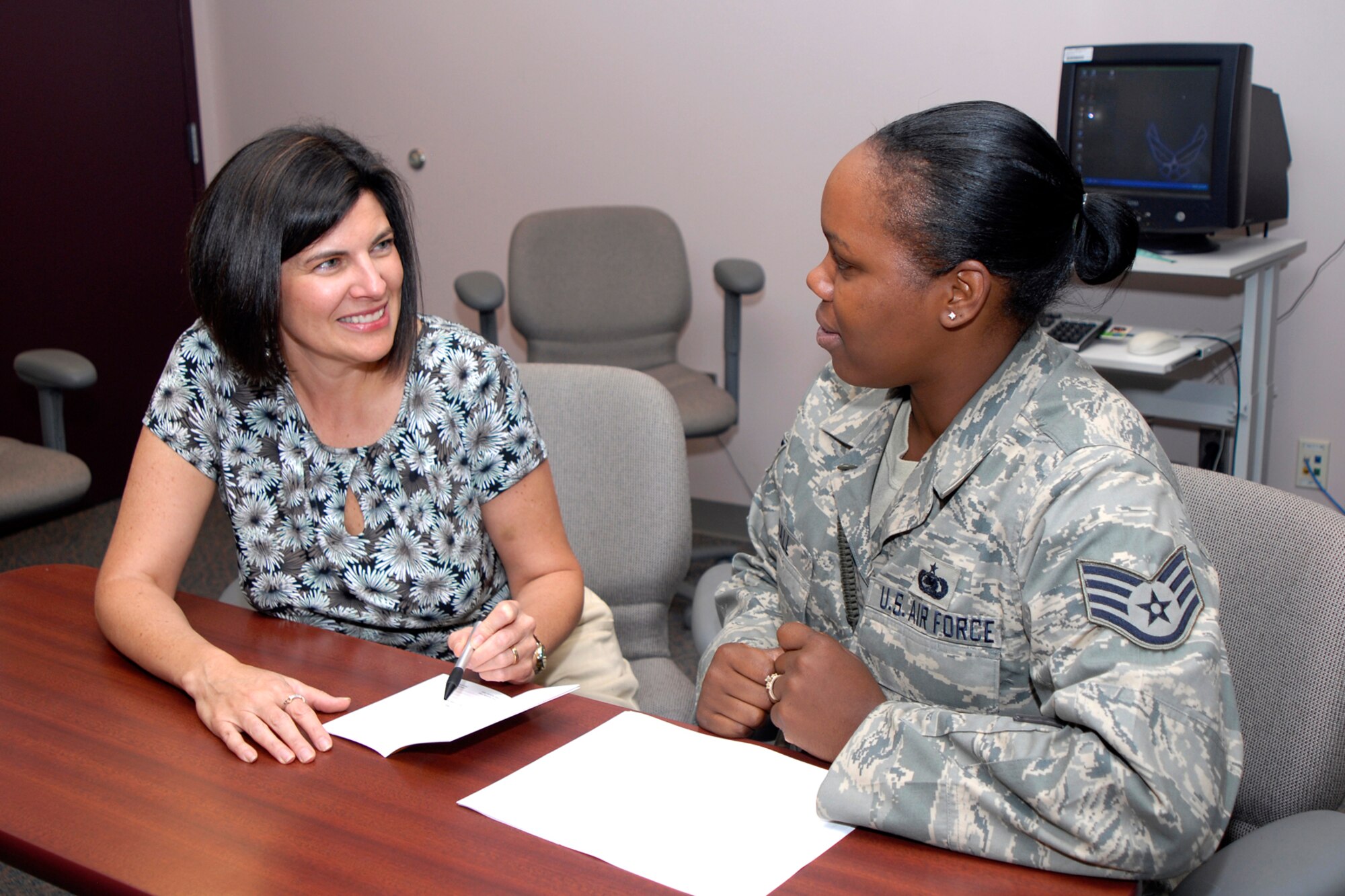 Terri Fisher, Health Educator for the Health and Wellness Center, reviews Staff Sgt. Tiffani Ball's food diary during the HAWC Lighten Up Program recently. Sergeant Ball is a supply operations specialist with the 16th Space Control Squadron. (U.S. Air Force photo/Craig Denton)
