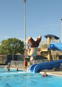 7/29/2008 - Airman Phillip Steen, 59th Dental Squadron, dives into the Warhawk Pool during the Check Six event July 29. Check Six is an outreach program intended to provide inspiration and enjoyment to Team Lackland's dorm residents. The event featured free food, door prizes, music and entertainment.  (USAF photo by Alan Boedeker)                       