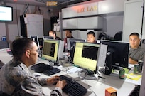 First Lt. Orlando Garcia responds to potential threats in the Incident Response Team Net Forensics Lab. Members of the team have two minutes to evaluate incoming threats. (USAF photo)