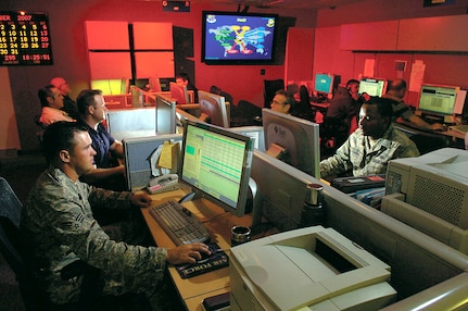 Senior Airman Adam Wick, left, and Staff Sgt. Ricardo Johnson investigate potential threats on the 33rd Network Warfare Squadron operations floor. The 33rd NWS monitors computer networks for the Air Force U.S. Central Command and U.S. Joint Forces Command. (USAF photo)