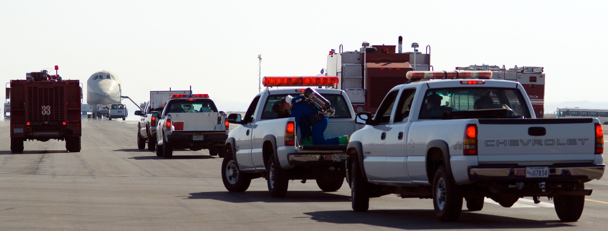 Edwards firefighters respond to a simulated orbiter crash during a base space shuttle emergency July 26. The exercise tested emergency response capabilities to an emergency shuttle landing. (Air Force photo by Mike Cassidy) 
