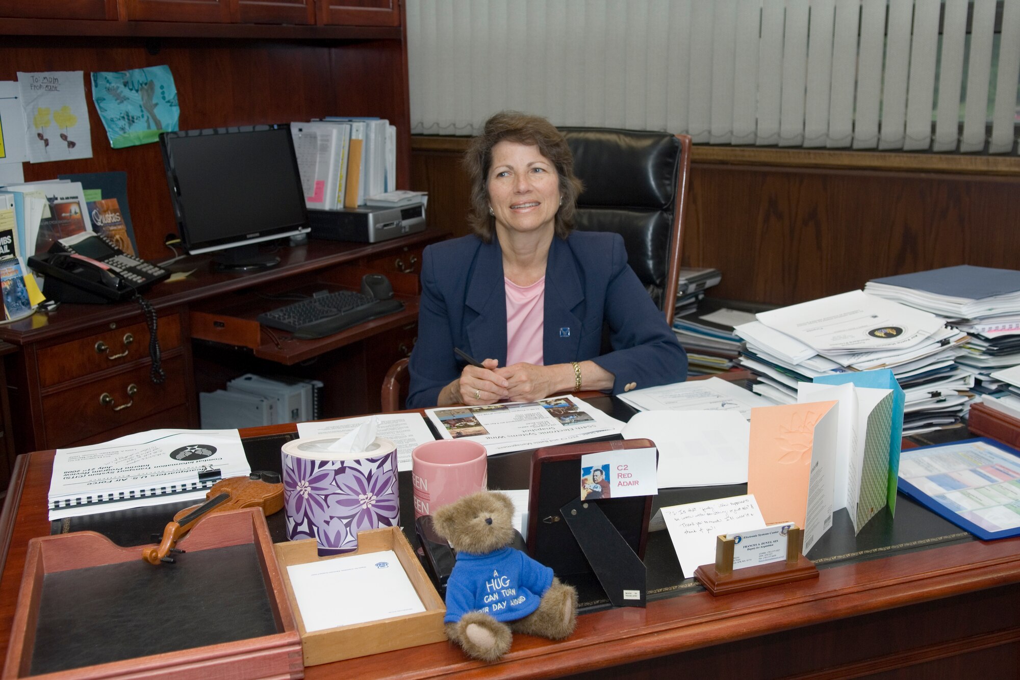 Outgoing Electronic Systems Center Executive Director Fran Duntz looks up while working at her desk last week. Mrs. Duntz, the center’s top civilian employee, will retire tomorrow following 31 years of federal service, although her luncheon and official ceremony will be held Aug. 8 in Hanscom’s Minuteman Club.  (Photo by Rick Berry)
