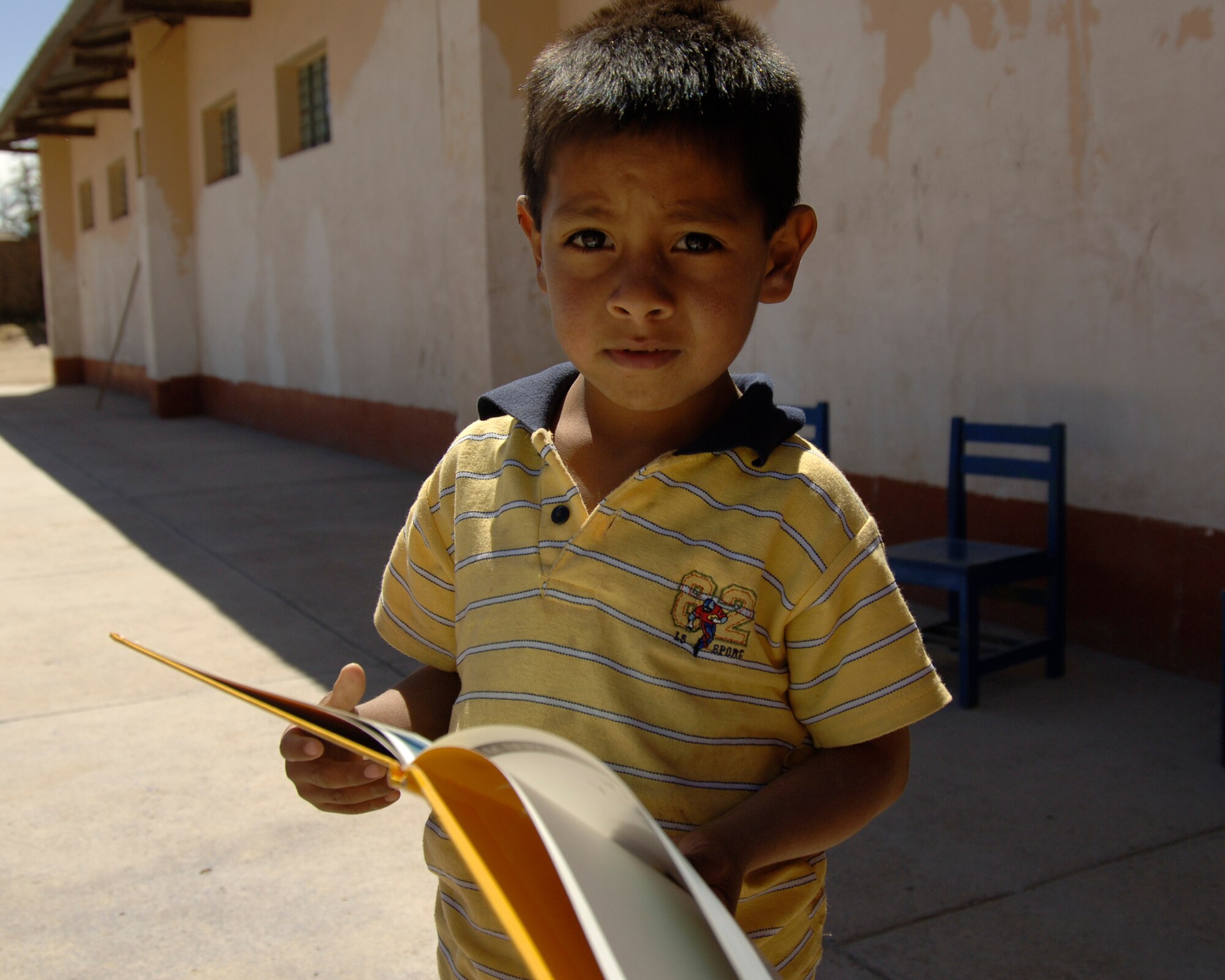 A Peruvian orphan holds a book given to him by Task Force New Horizons members at a medical mission in Cobadonga, Peru, July 26.  The task force is deployed to Ayacucho, Peru to support New Horizons - Peru 2008, a U.S. and Peruvian humanitarian effort to bring relief to underpriviliged Peruvians.  (U.S. Air Force photo/1st Lt. Mary Pekas)