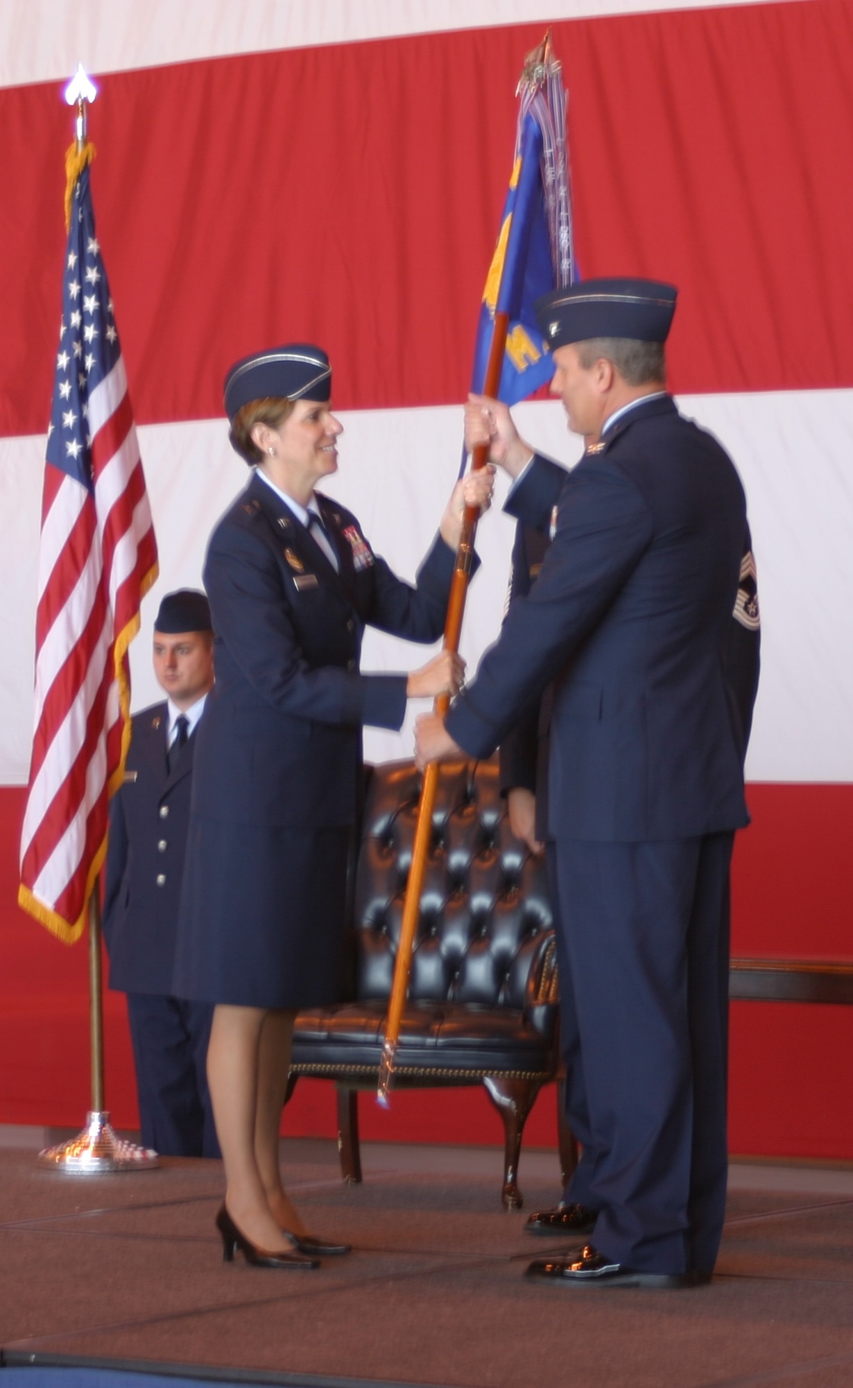 Brig. General Lori Robinson, commander, 552nd Air Control Wing passes command of the 552nd Maintenance Group to Colonel Lawrence Hinkin in an Assumption of Command ceremony July 1.