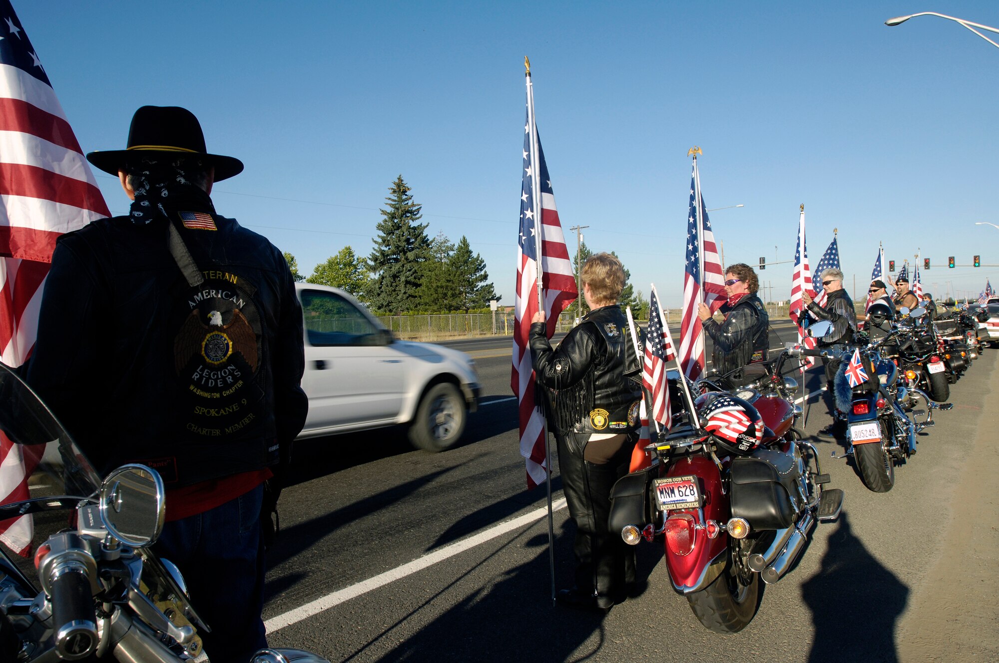 FAIRCHILD AIR FORCE BASE, Wash. – The Spokane chapter of the Veteran American Legion Riders greet members of the 92nd Air Refueling Wing as they report for duty here July 25. The group stood across the street from at the main gate for an hour shaking hands and applauding base personnel. (U.S. Air Force photo / Senior Airman Eunique Stevens)