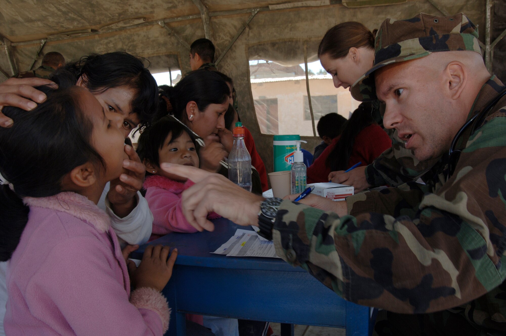 Lt. Cmdr. Bill Fernandez, a Task Force New Horizons doctor, performs triage on a Peruvian girl during a medical mission in Cobadonga, Peru, July 26.  The Operational Health Support Unit - Great Lakes, Ill., is supporting three of nine medical missions for New Horizons - Peru 2008, a humanitarian U.S. and Peruvian effort to bring quality-of-life projects to the people of Ayacucho, Peru.  (U.S. Air Force photo/1st Lt. Mary Pekas)